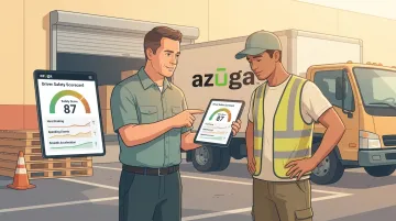 Fleet manager coaching driver using tablet showing safety score dashboard