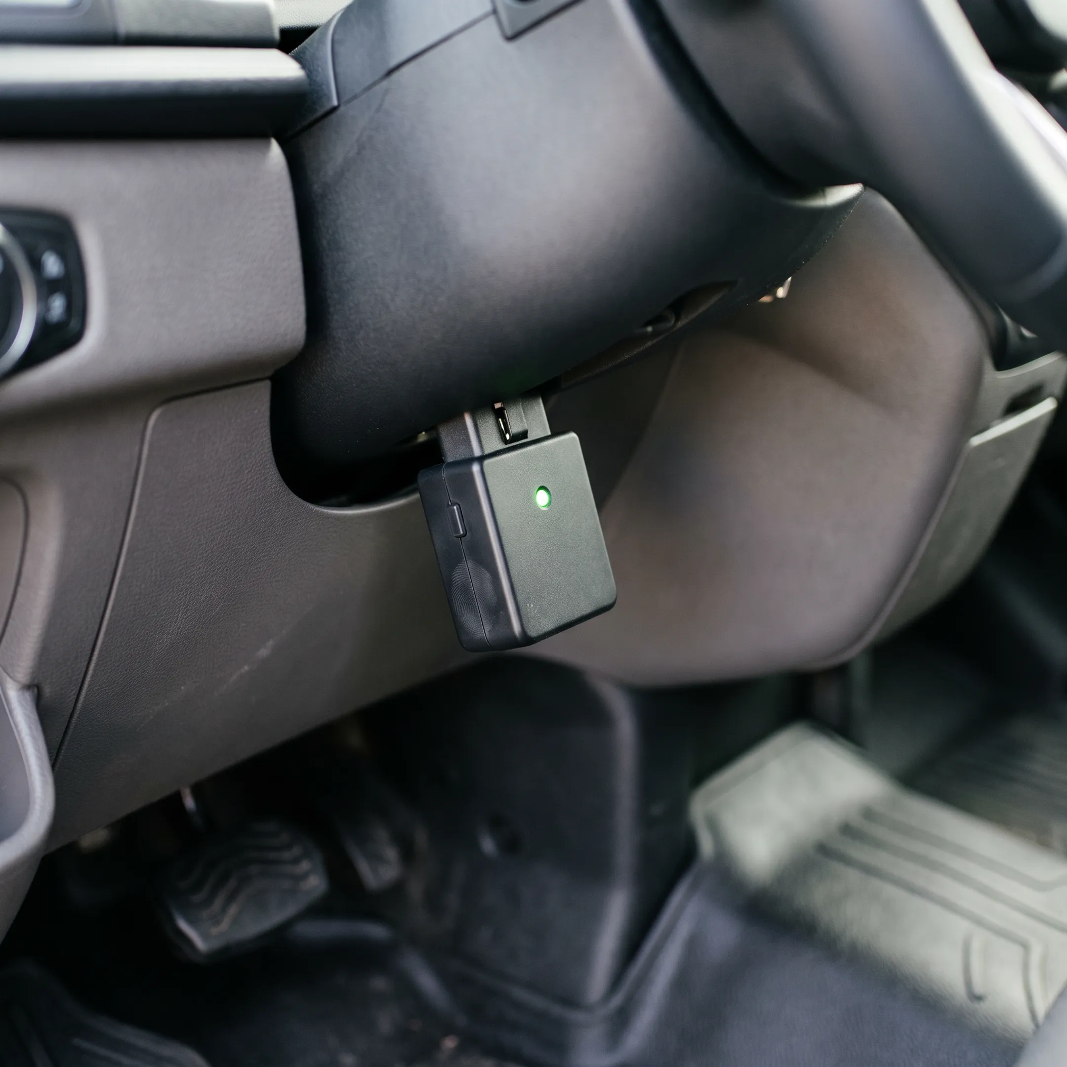 OBD2 fleet device connected inside a commercial vehicle