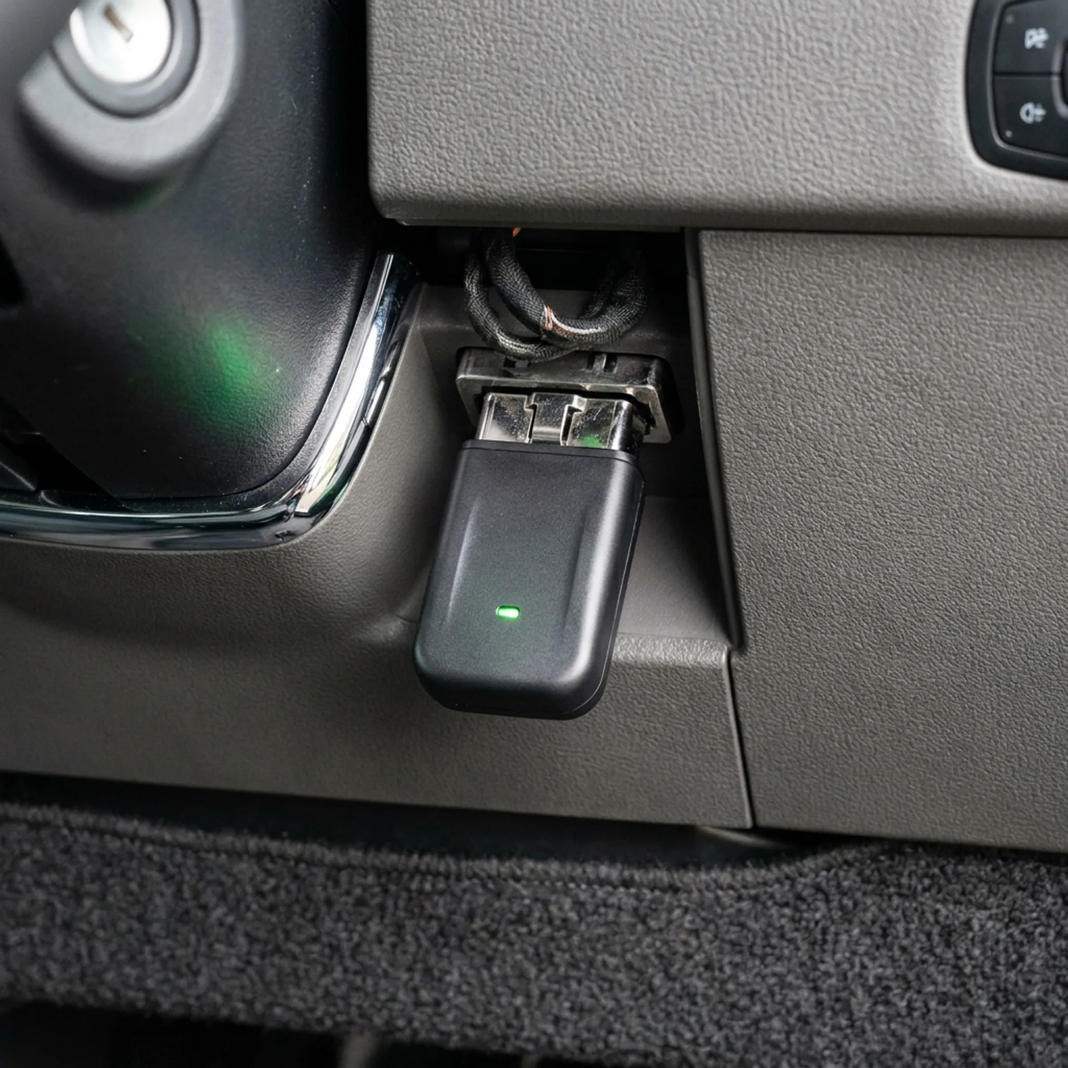 OBD port GPS tracking device installed underneath the steering column of a commercial service van