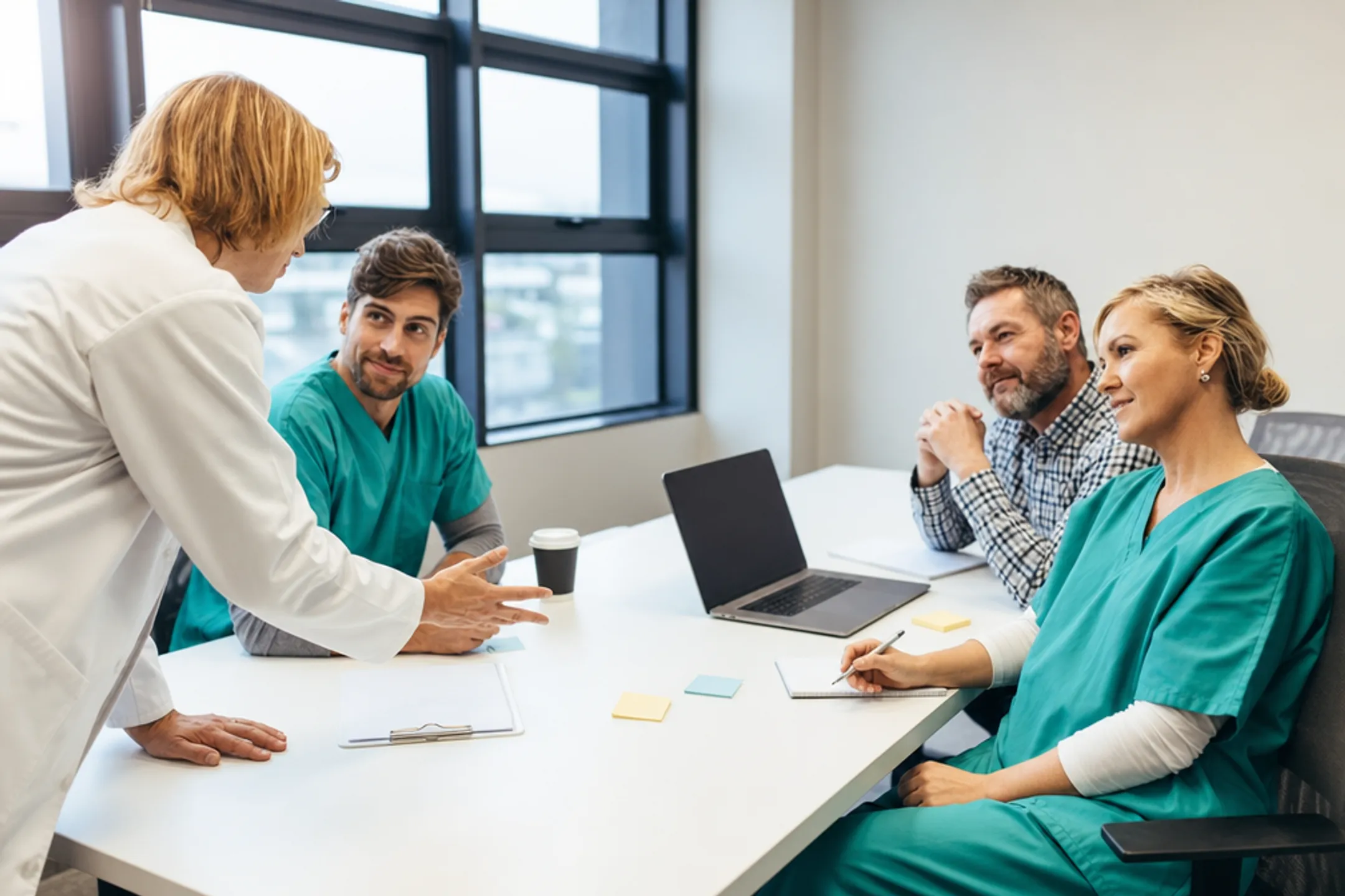 Healthcare team reviewing a near miss during a safety huddle