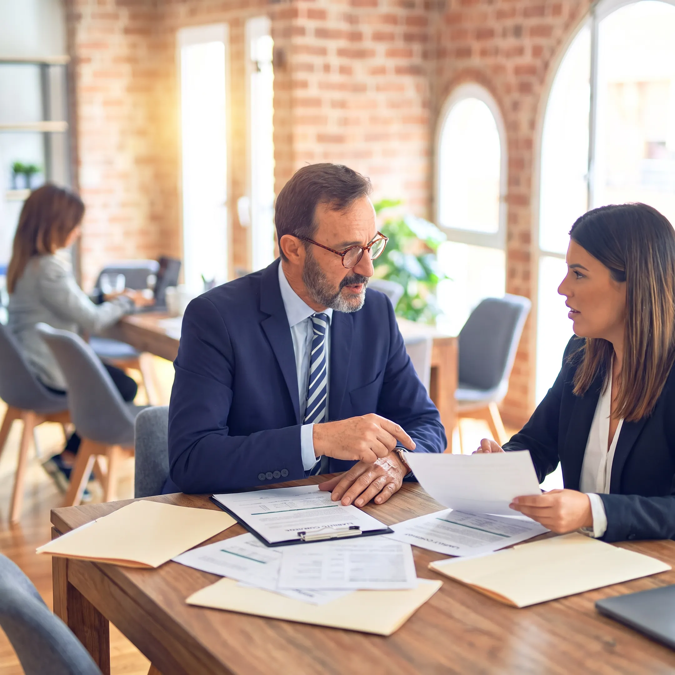 Business owner reviewing general liability insurance documents with an insurance advisor