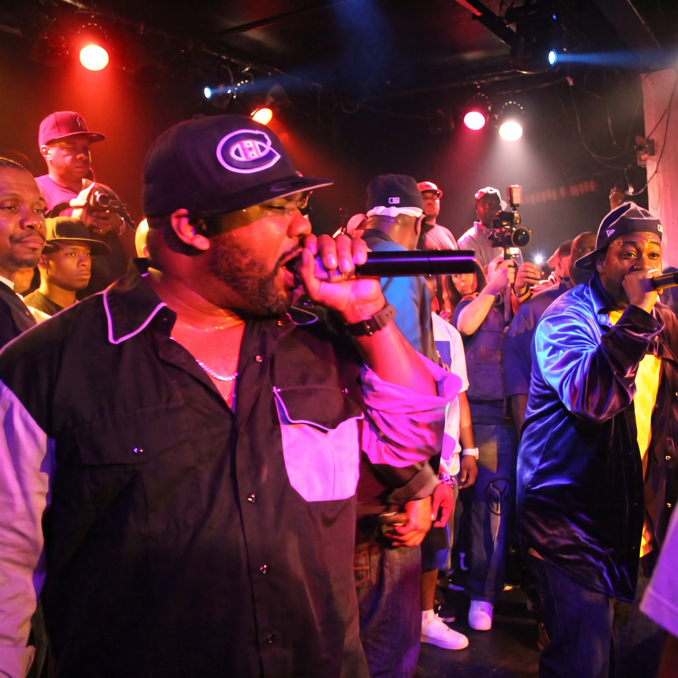 Live concert performance with an artist commanding the stage under spotlights