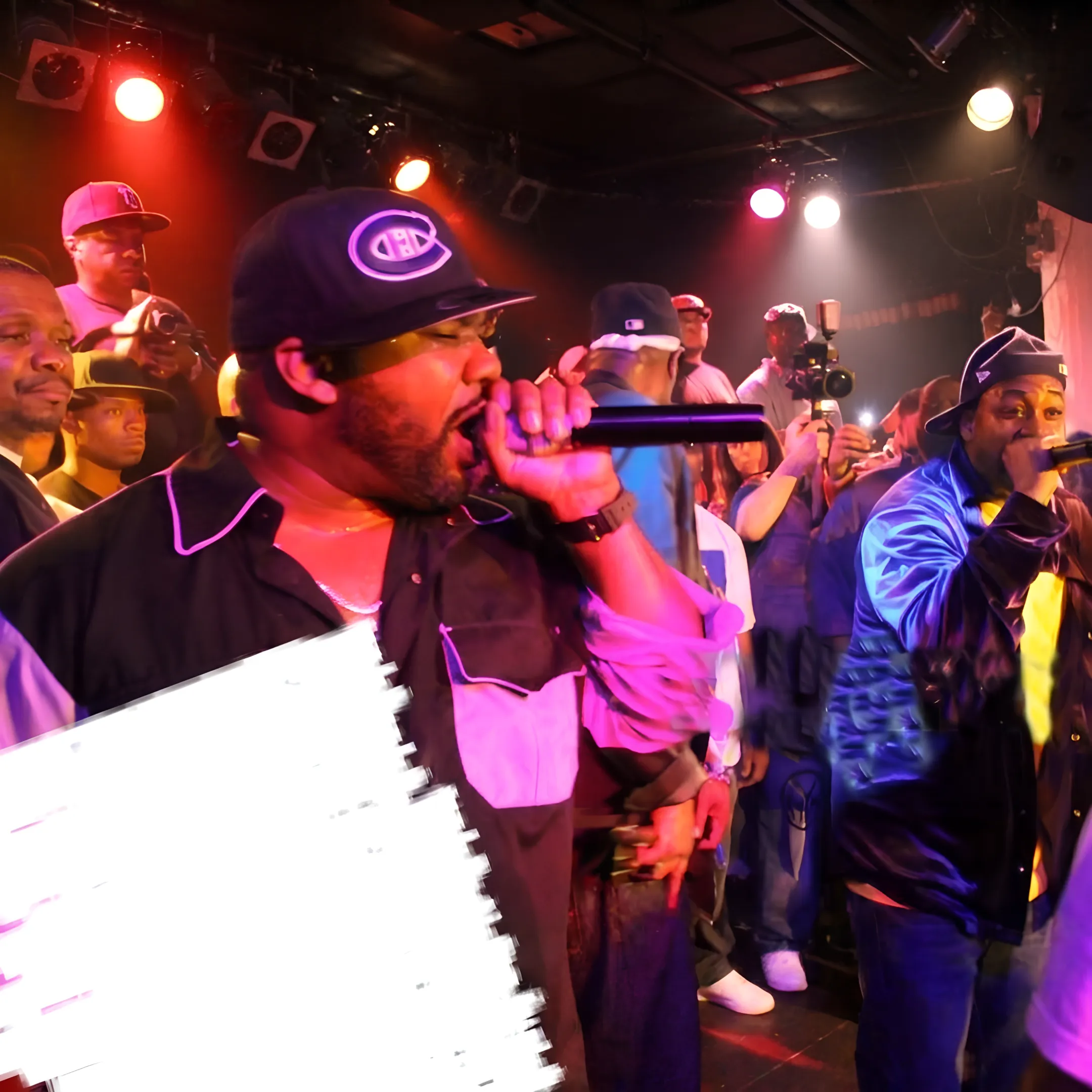 Live hip-hop concert performance with a rapper on stage under bright concert lights