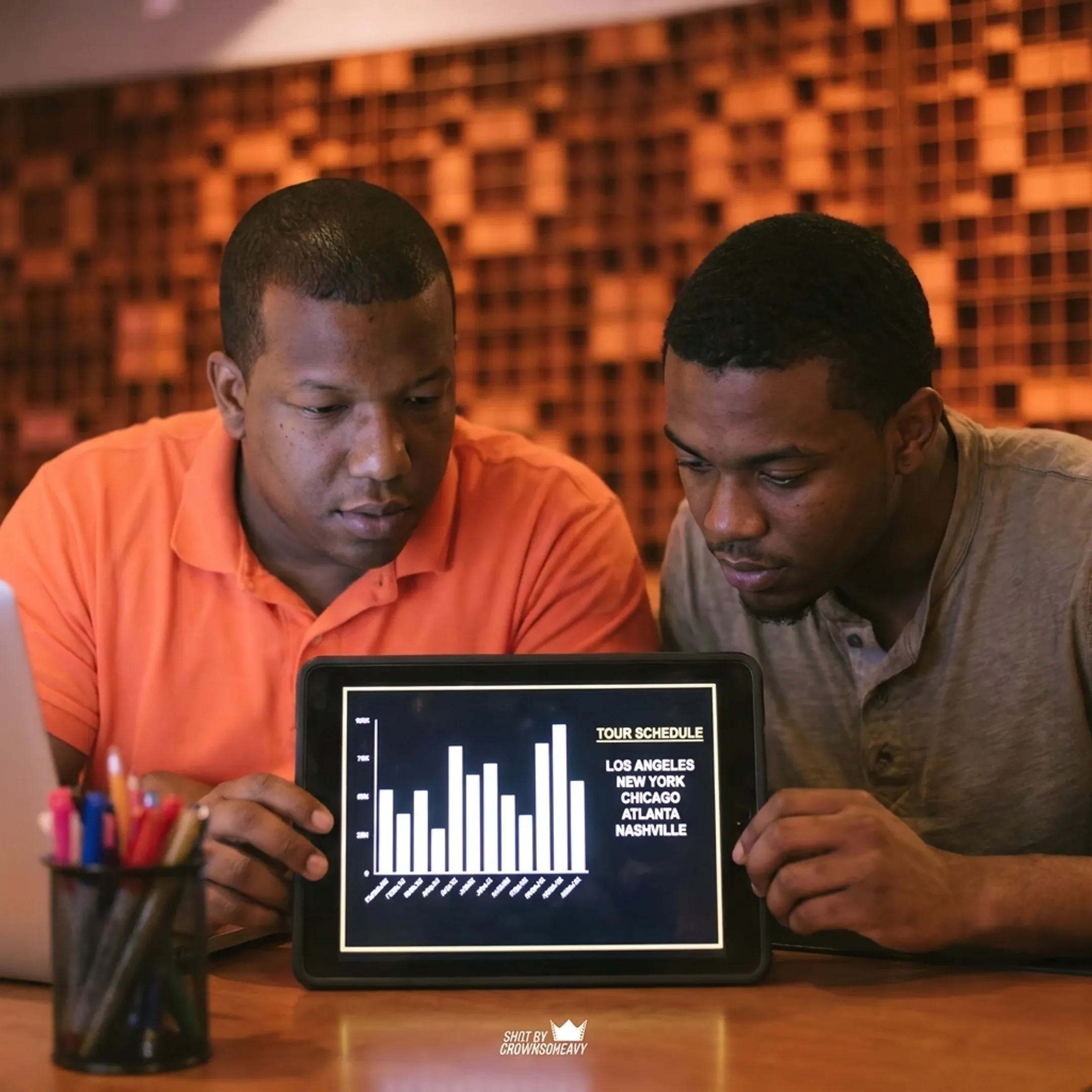 Artist manager strategizing album rollout in recording studio
