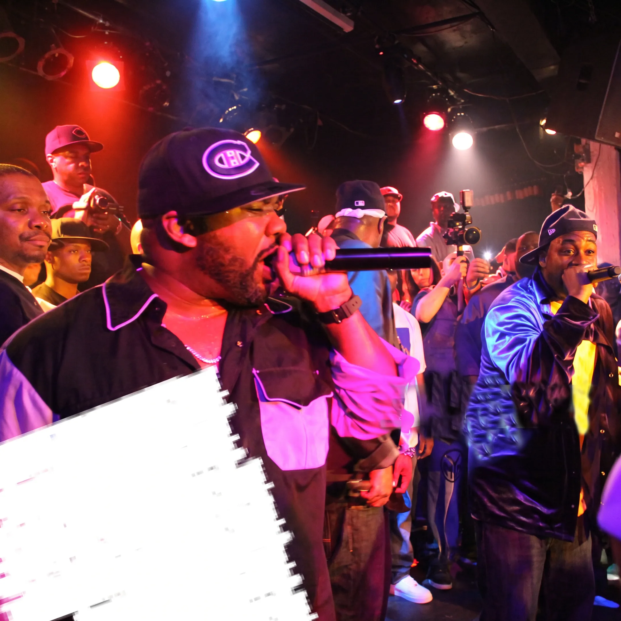 Artist performing on stage under concert lights managed by representation agency