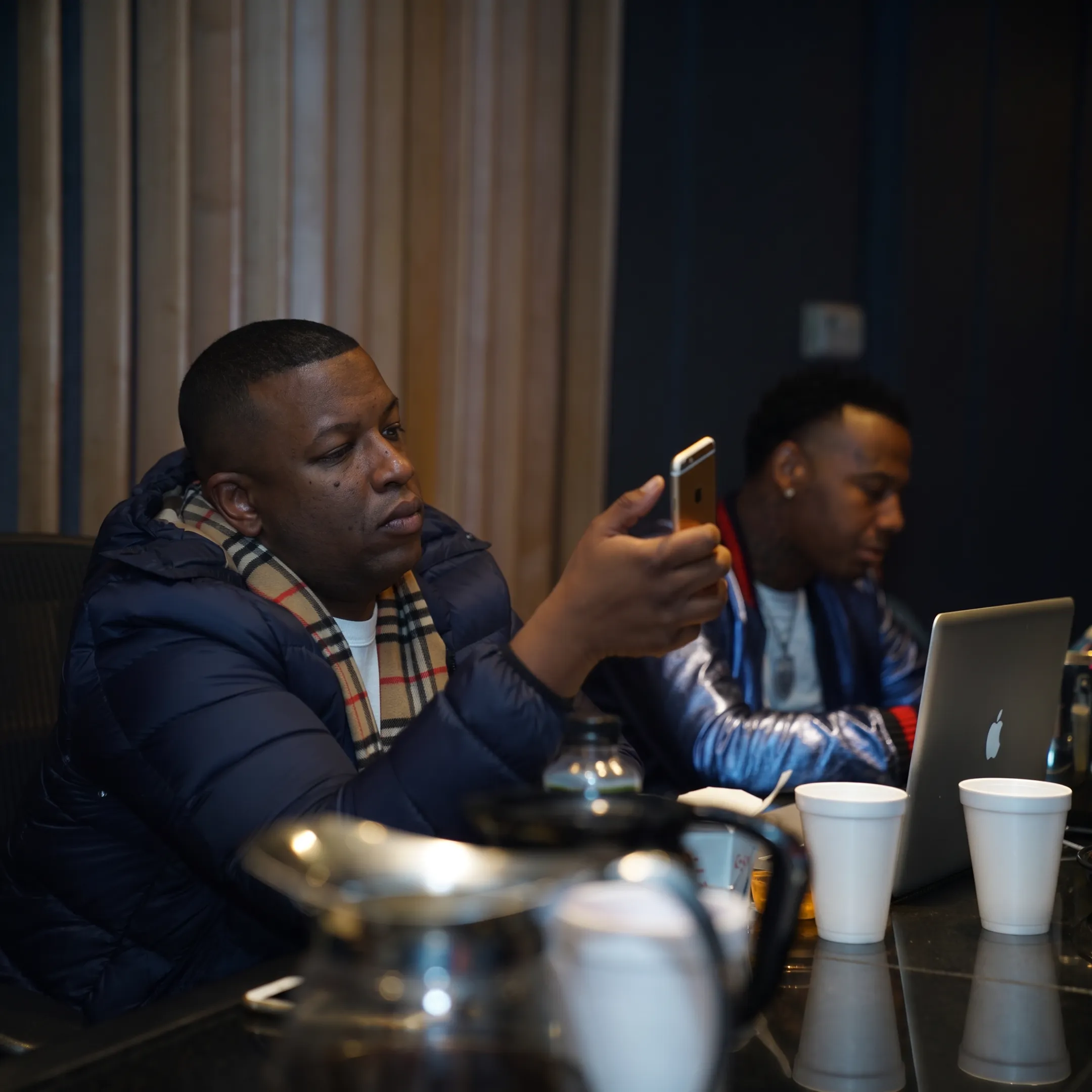 Artist manager reviewing music campaign plans with performer in a professional studio