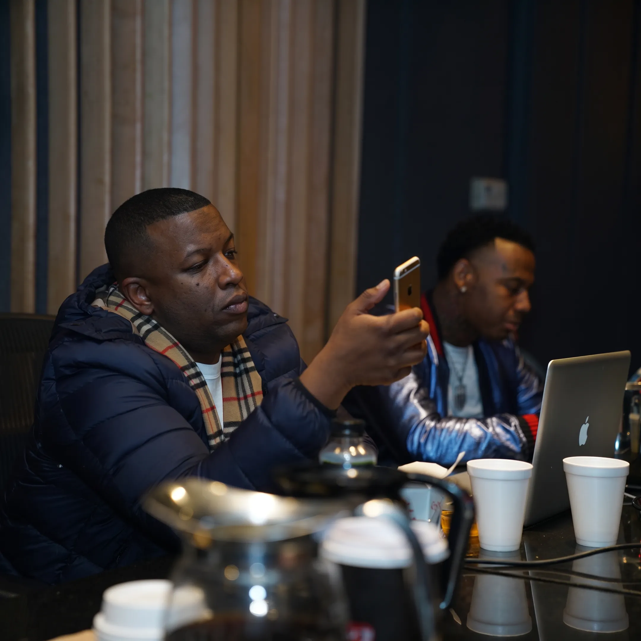 Artist manager reviewing music strategy with a recording artist in a New York studio