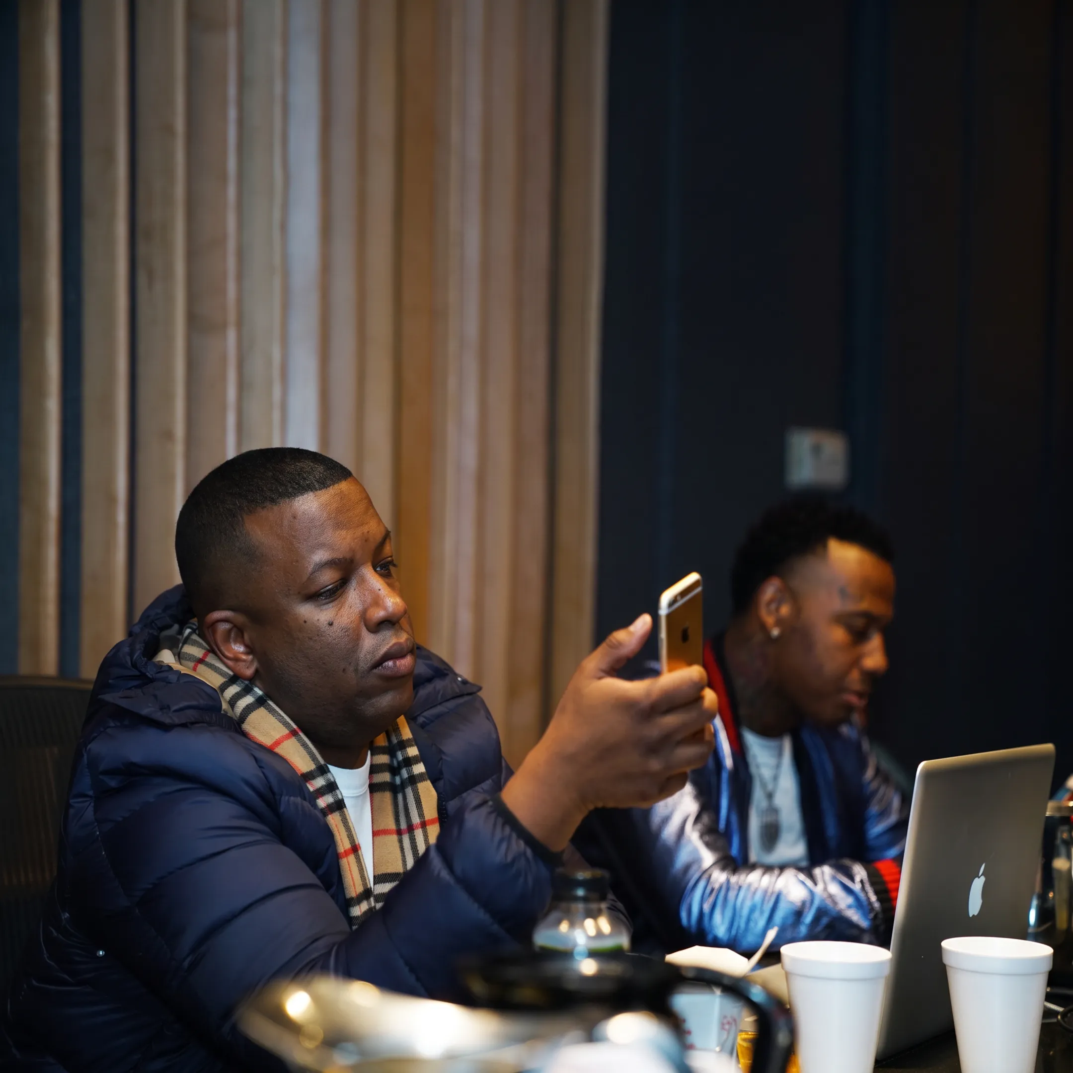 Entertainment manager advising recording artist during a focused studio consultation