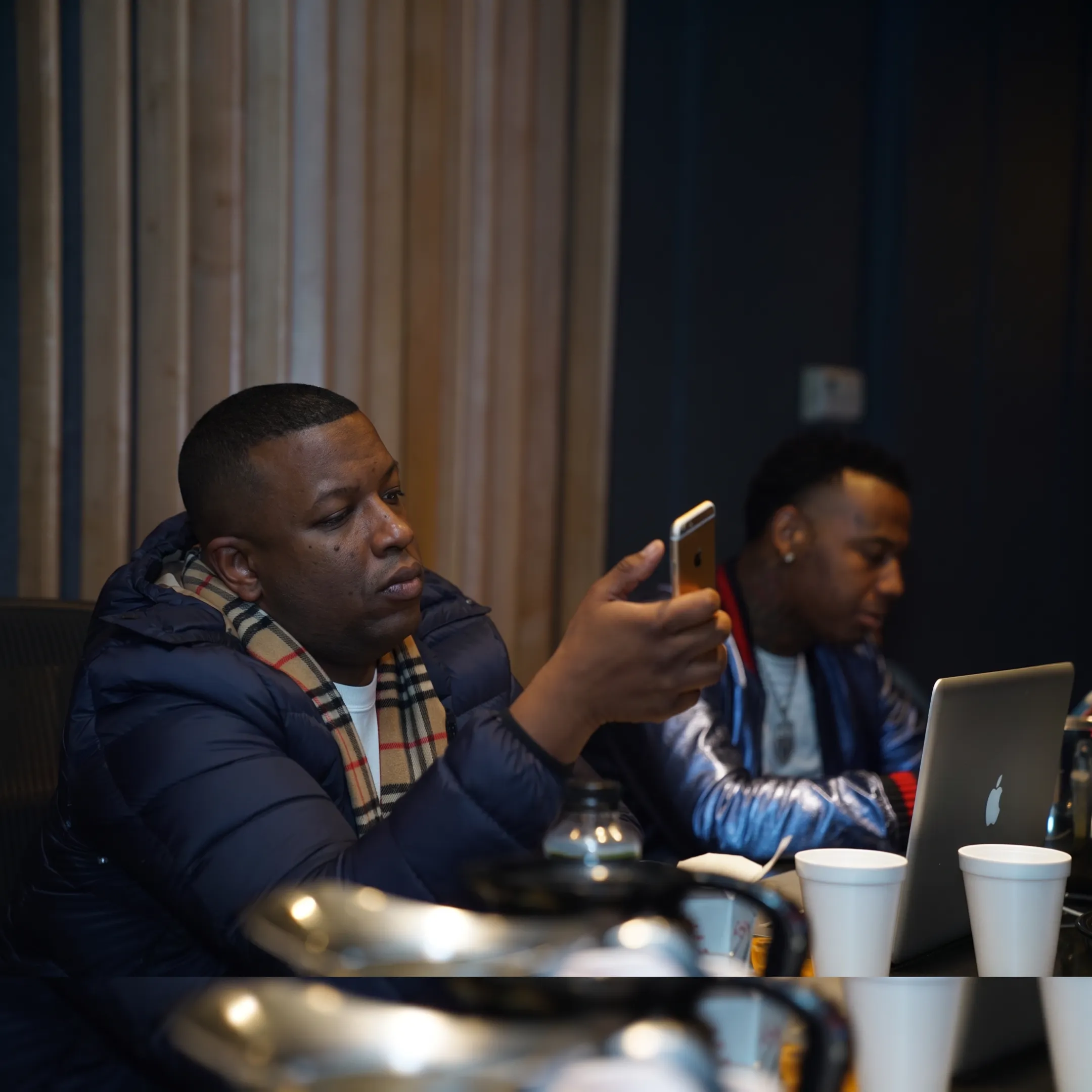 Music manager advising an artist during a focused studio consultation