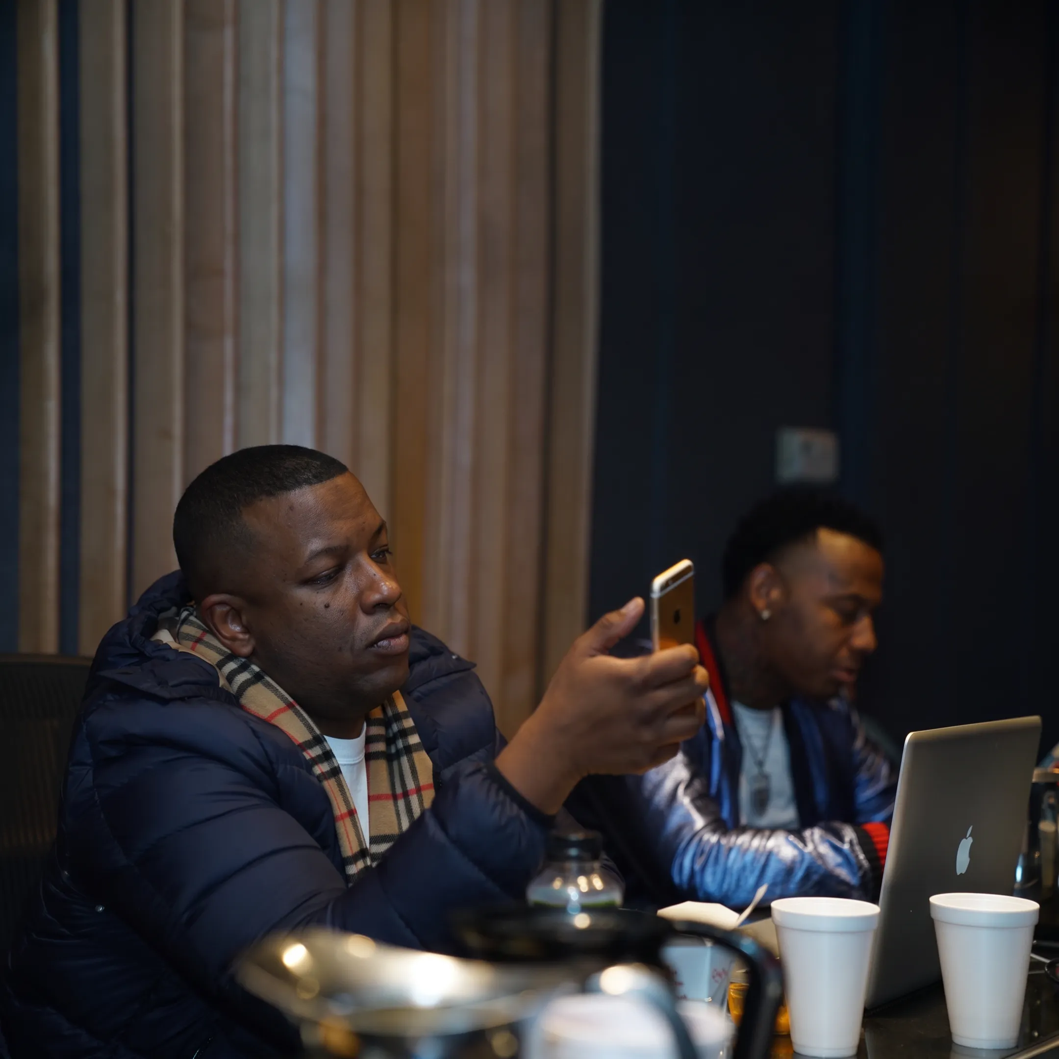Music promotion team reviewing an artist campaign beside studio equipment