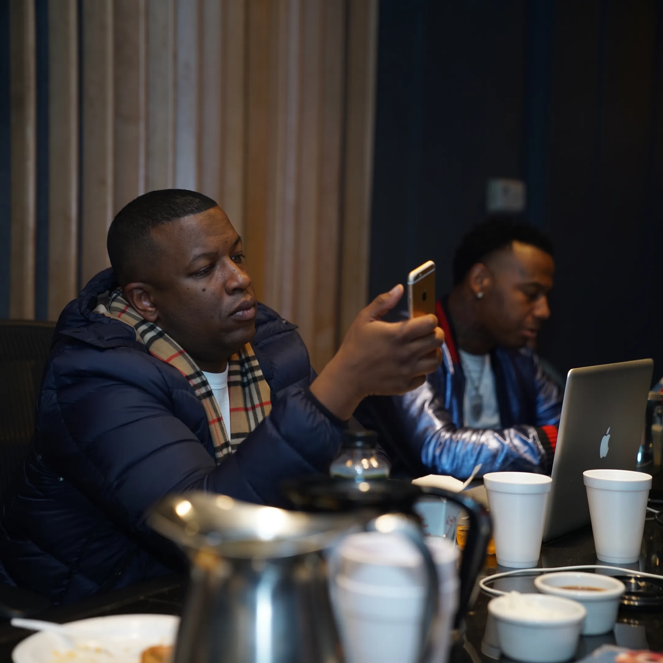 Music promotion team reviewing artist campaign materials in a Los Angeles studio