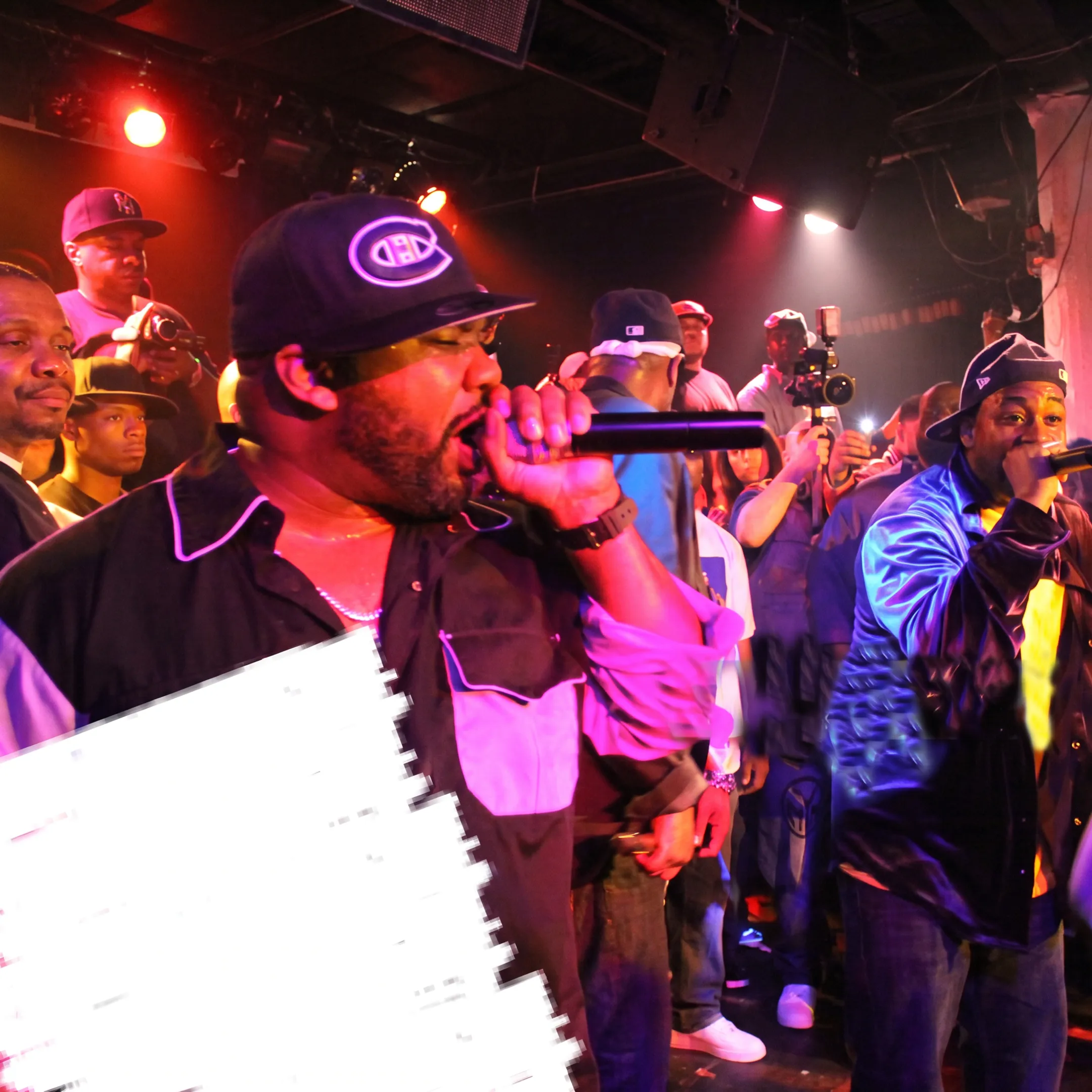 Event production team coordinating a Detroit concert with performers, lighting, guests, and production equipment