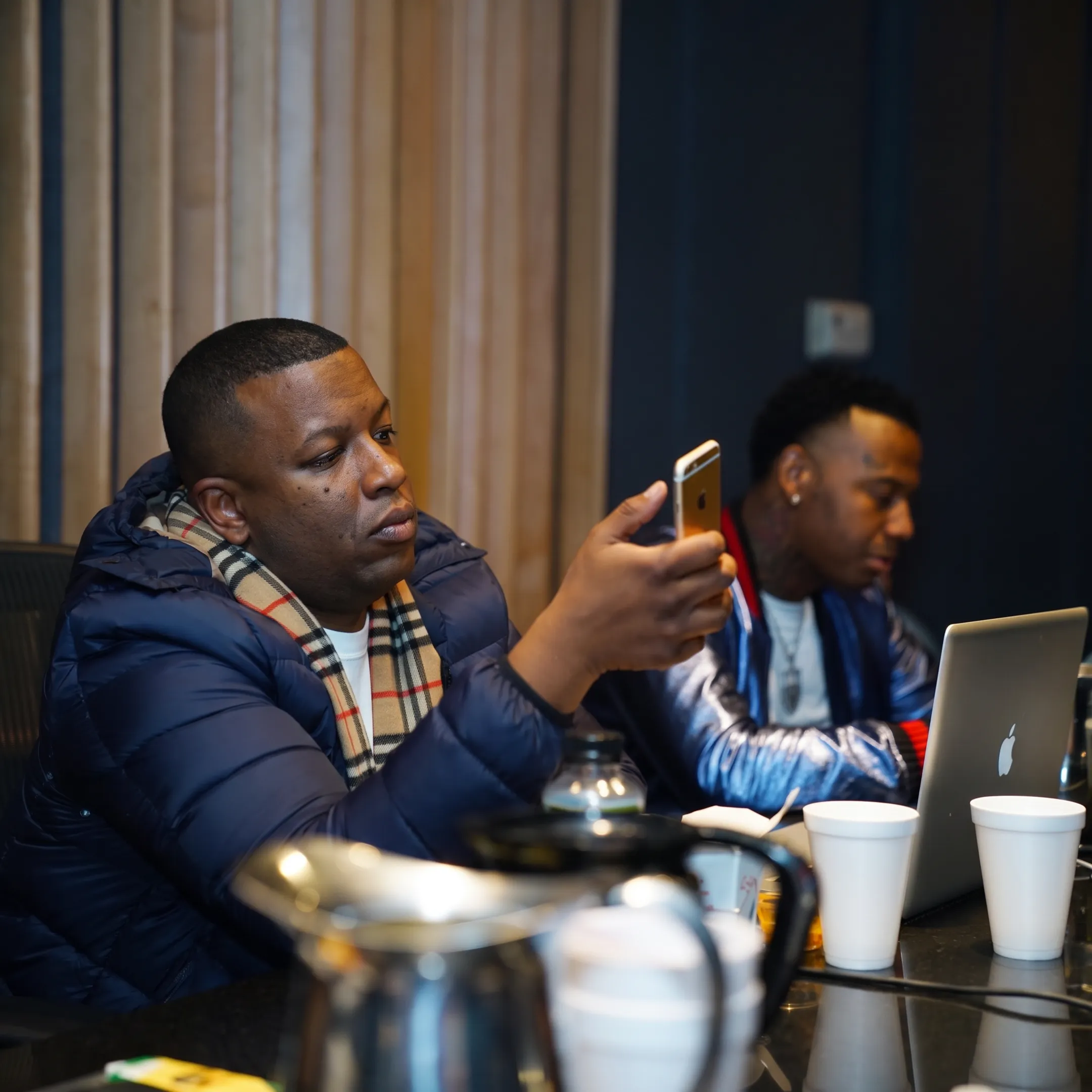 Entertainment publicist discussing media strategy with an artist in a creative studio