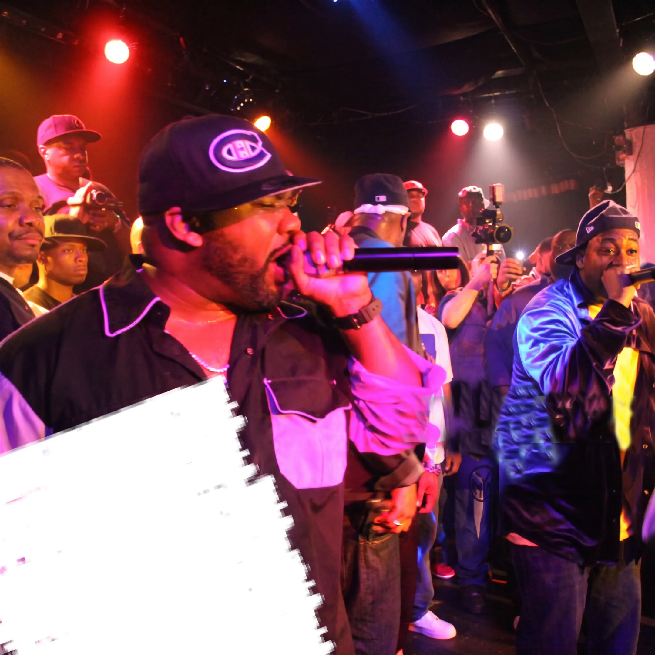 Entertainment professionals coordinating a live concert production with an artist on stage