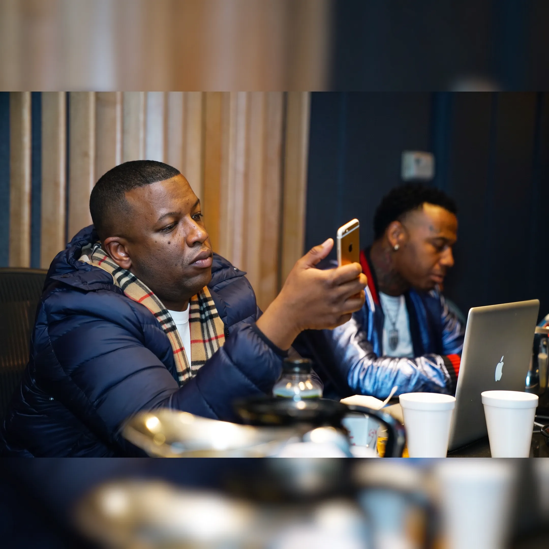 Artist manager and musician discussing a release strategy in a studio