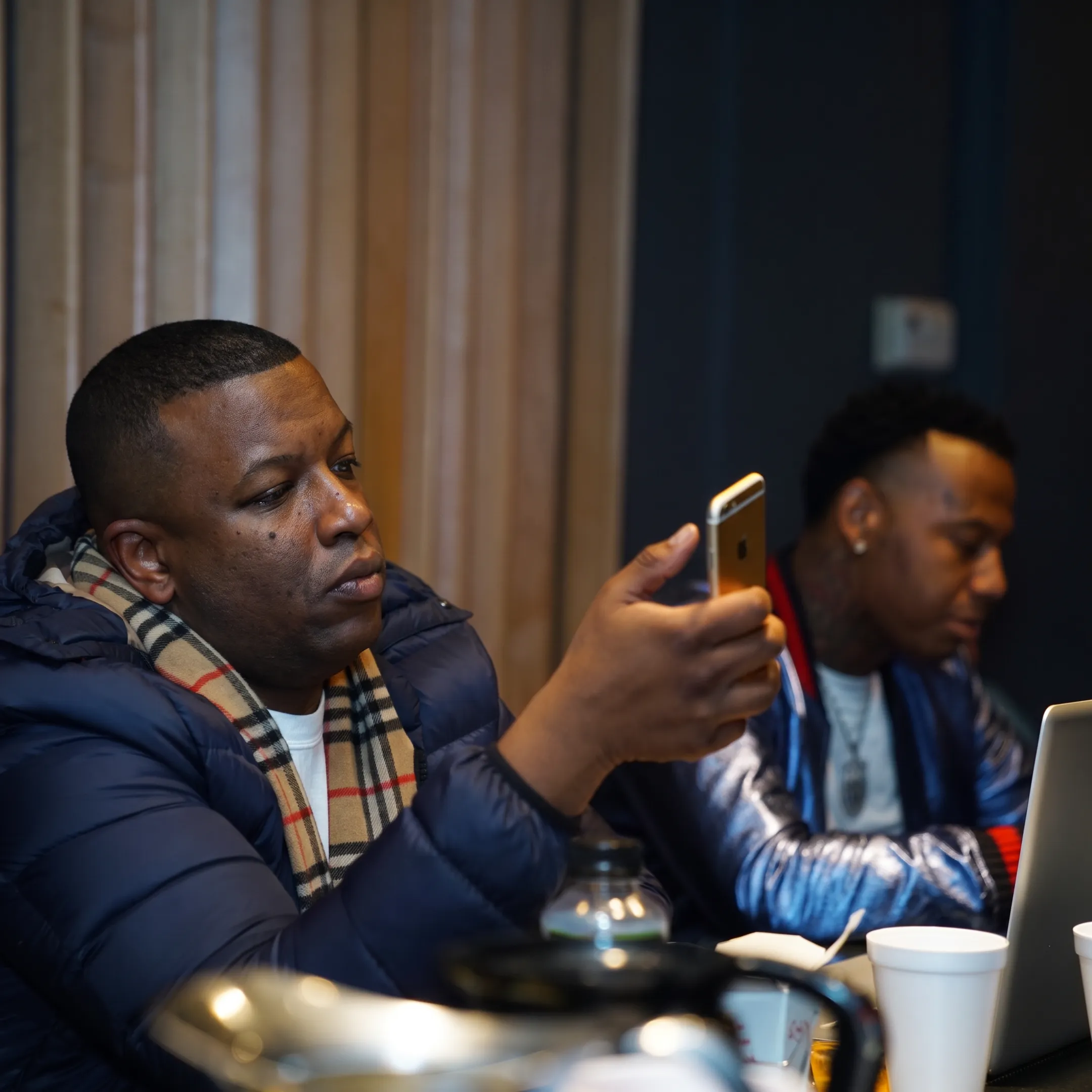 Music artist manager advising a performer during a creative meeting in a studio
