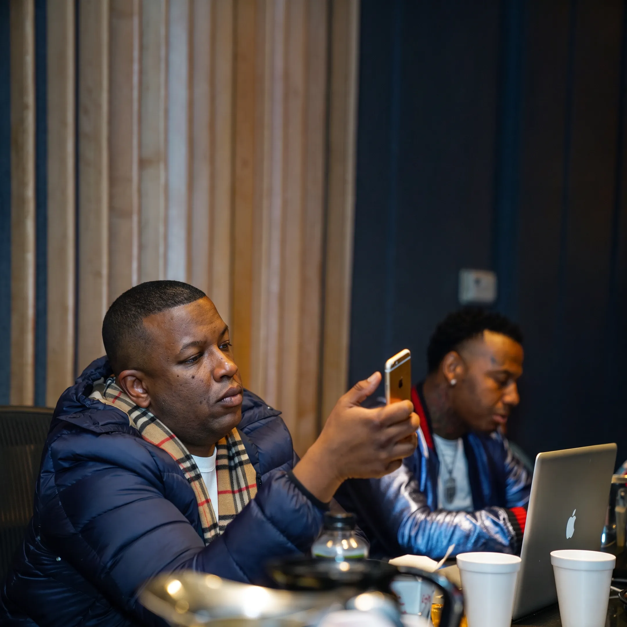 Music manager reviewing an artist career strategy with a performer in a recording studio