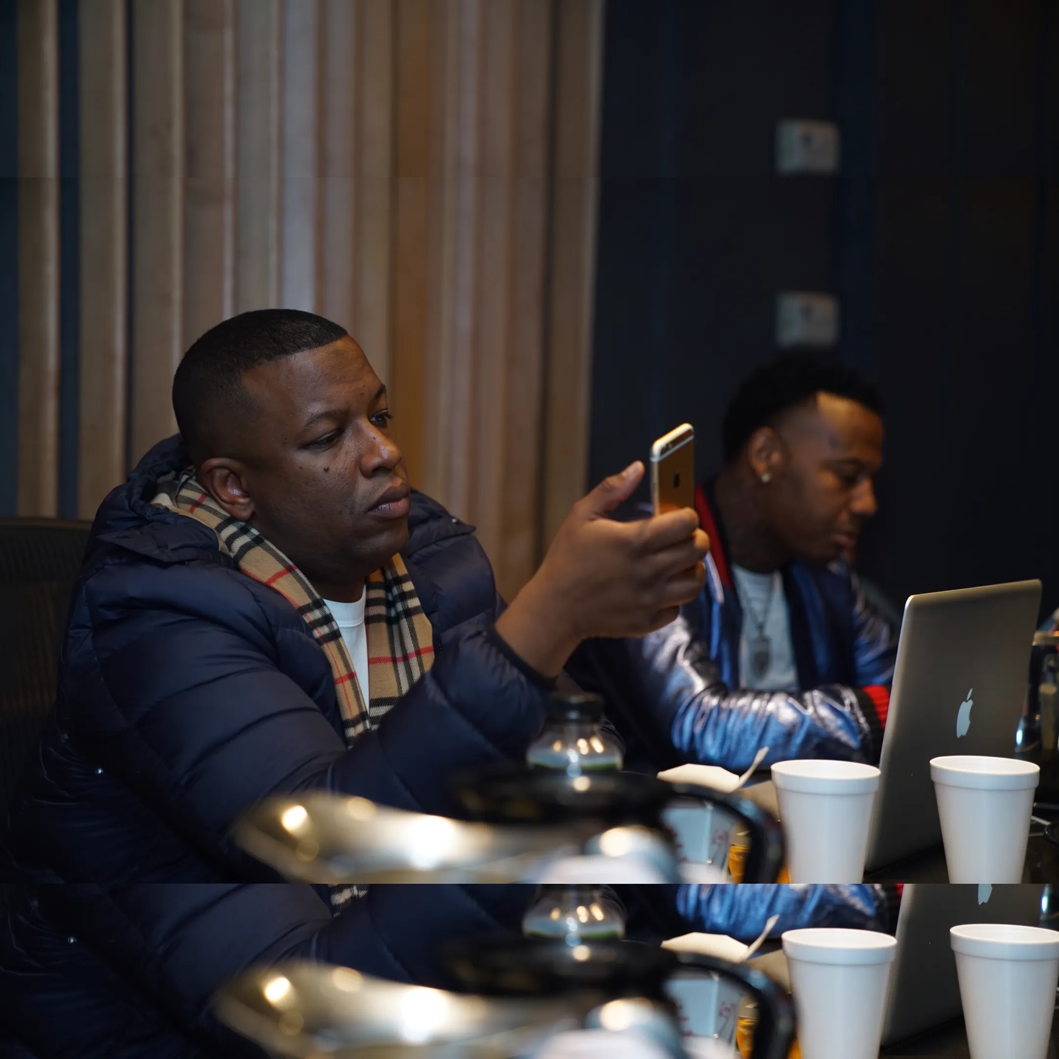Artist and music strategist discussing a promotional campaign beside release artwork
