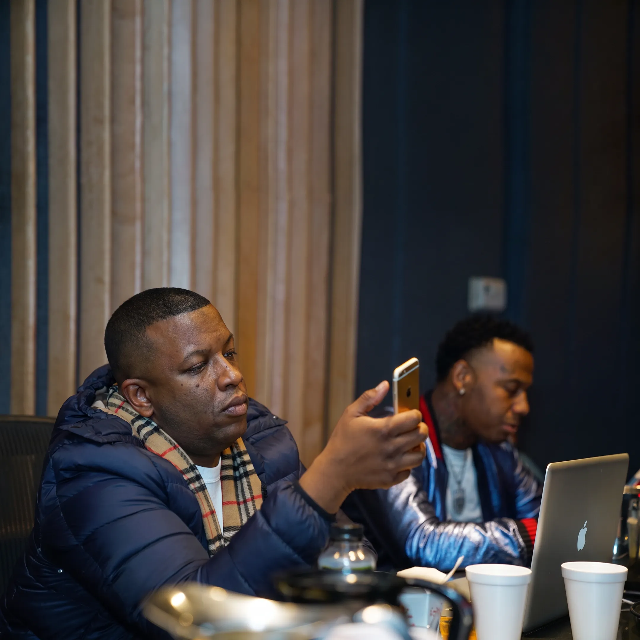 Artist manager consulting with a musician in a professional studio setting