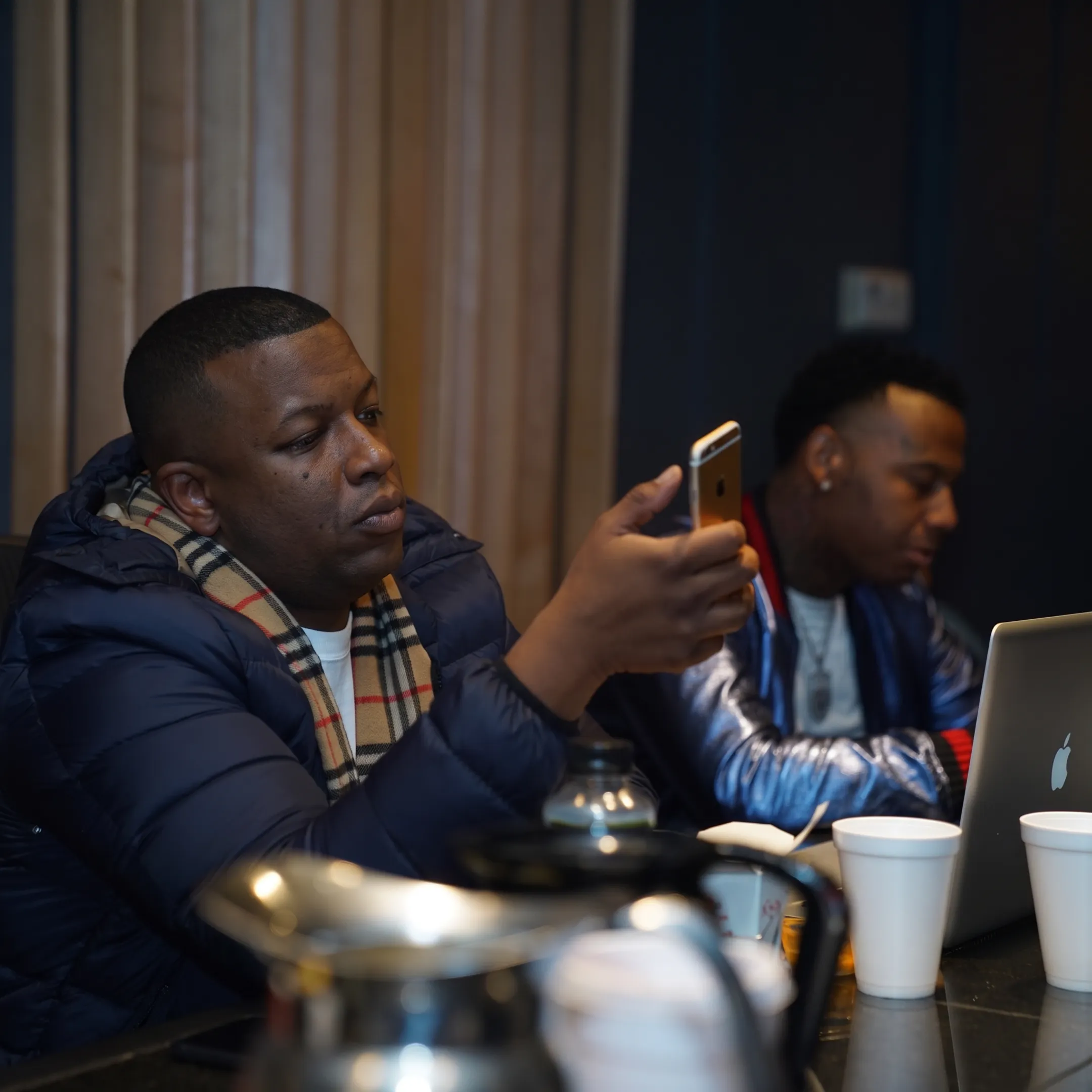 Music booking professional discussing tour plans with an artist in a creative studio