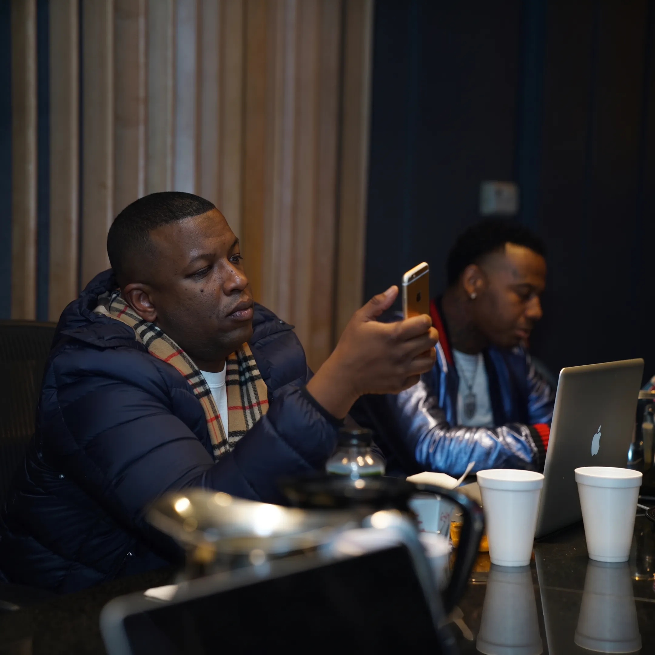 Entertainment manager consulting with an artist in a professional studio setting