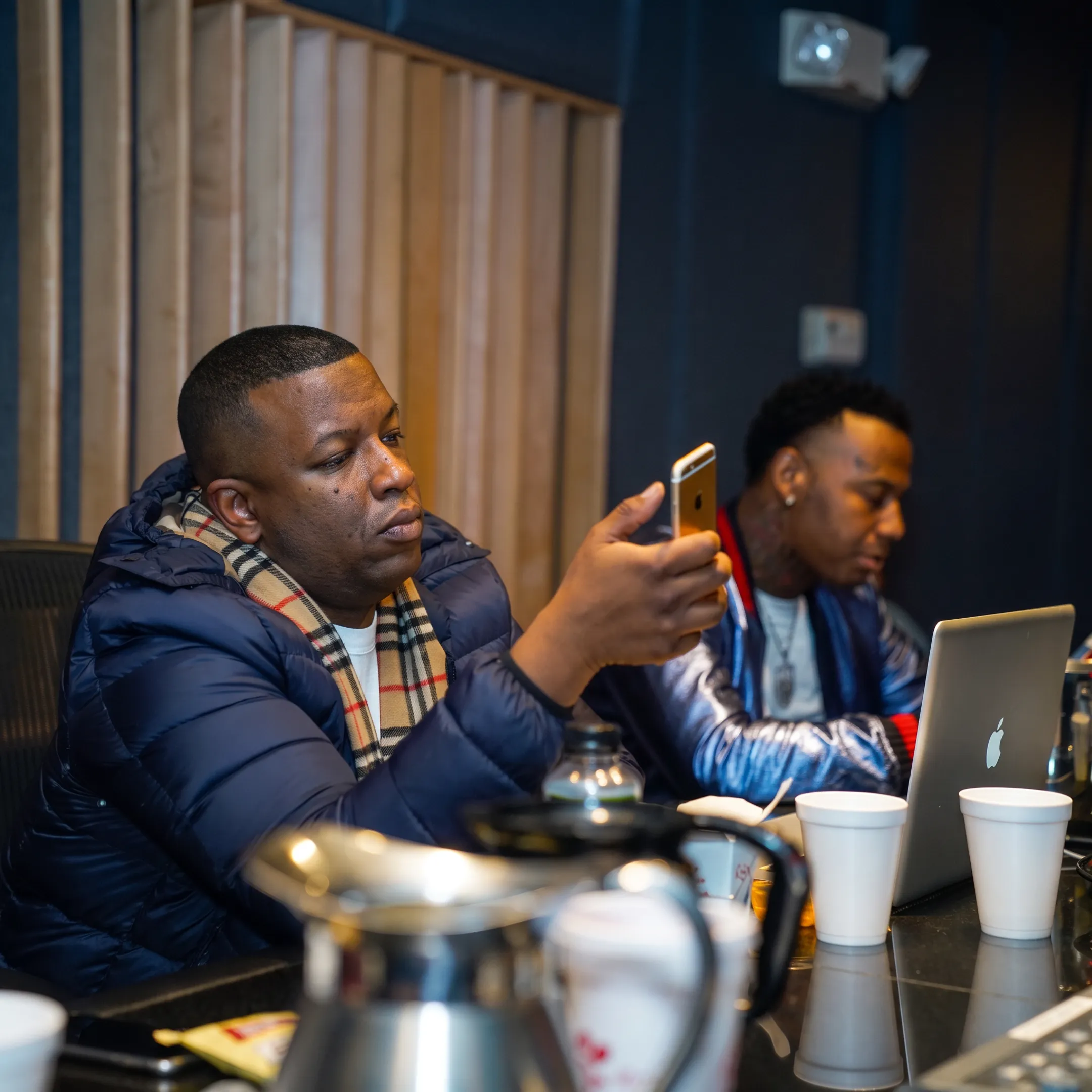 Music artist collaborating with a management team in a creative studio