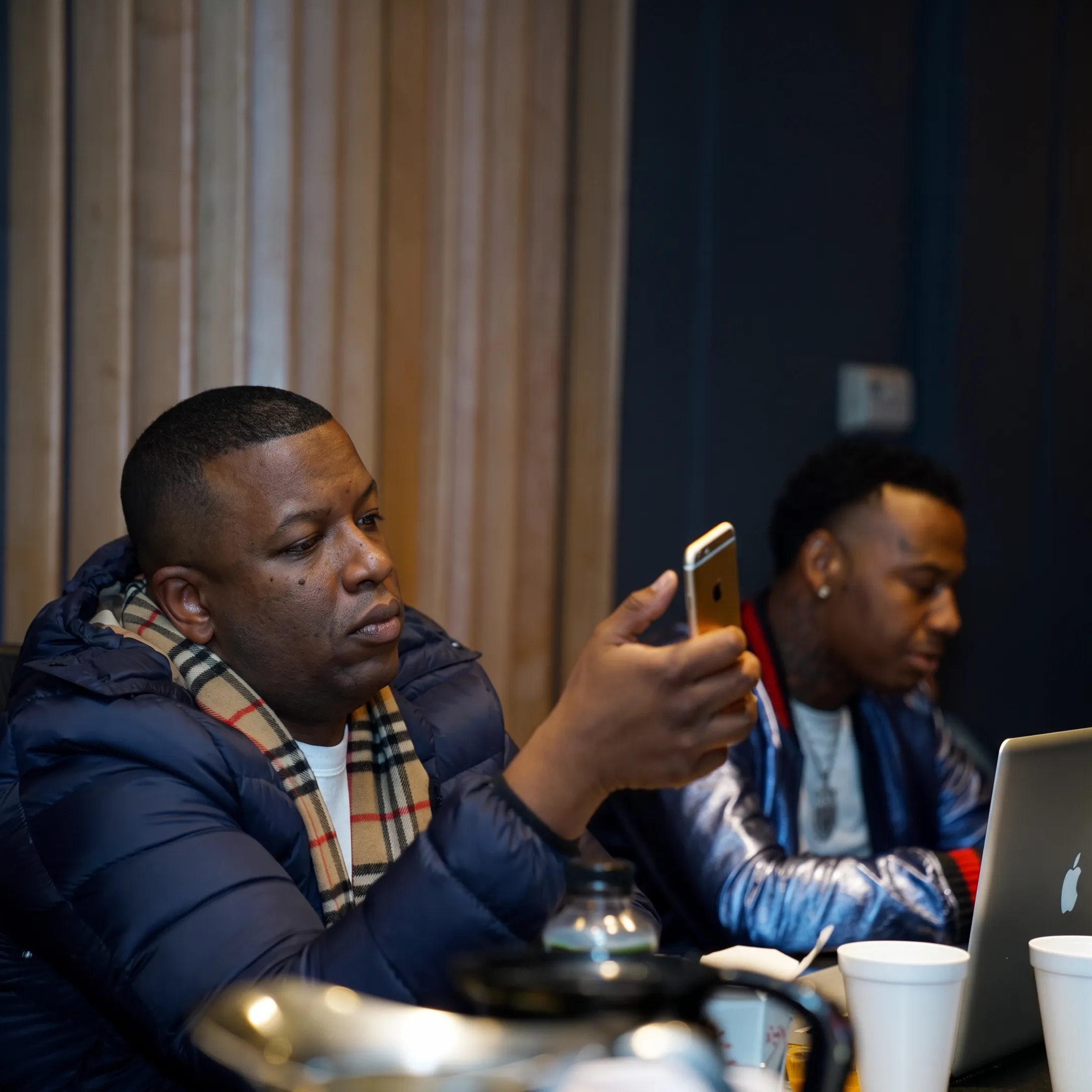Music promotion strategist reviewing an artist campaign with a hip-hop performer