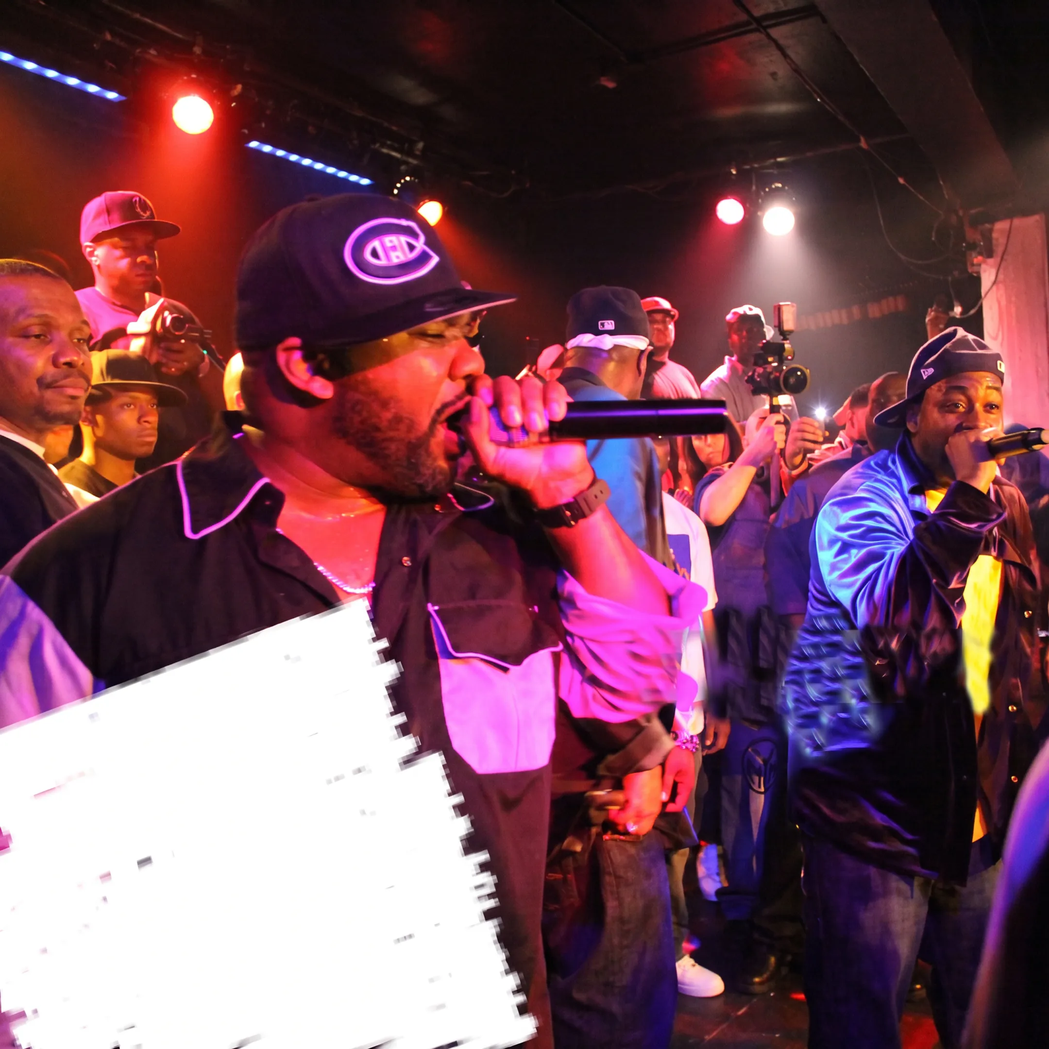 Rap artist performing onstage at a professionally produced live music event