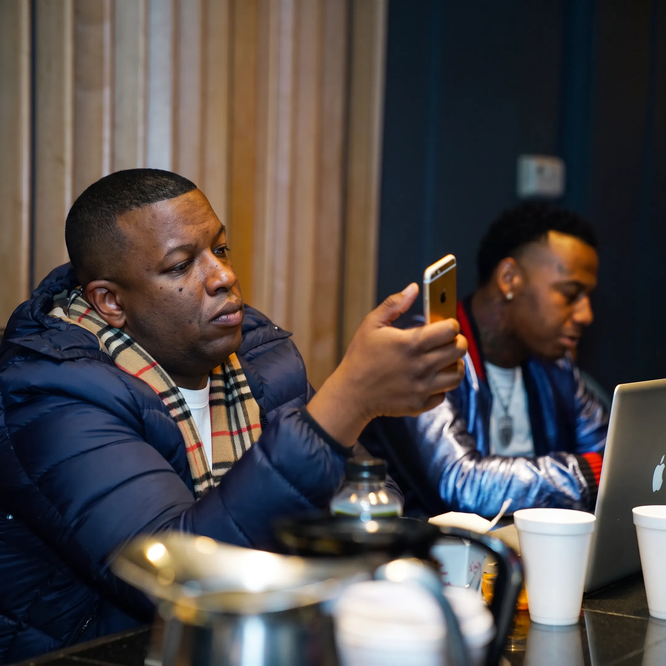 Music marketing team reviewing artist campaign materials in a Nashville studio