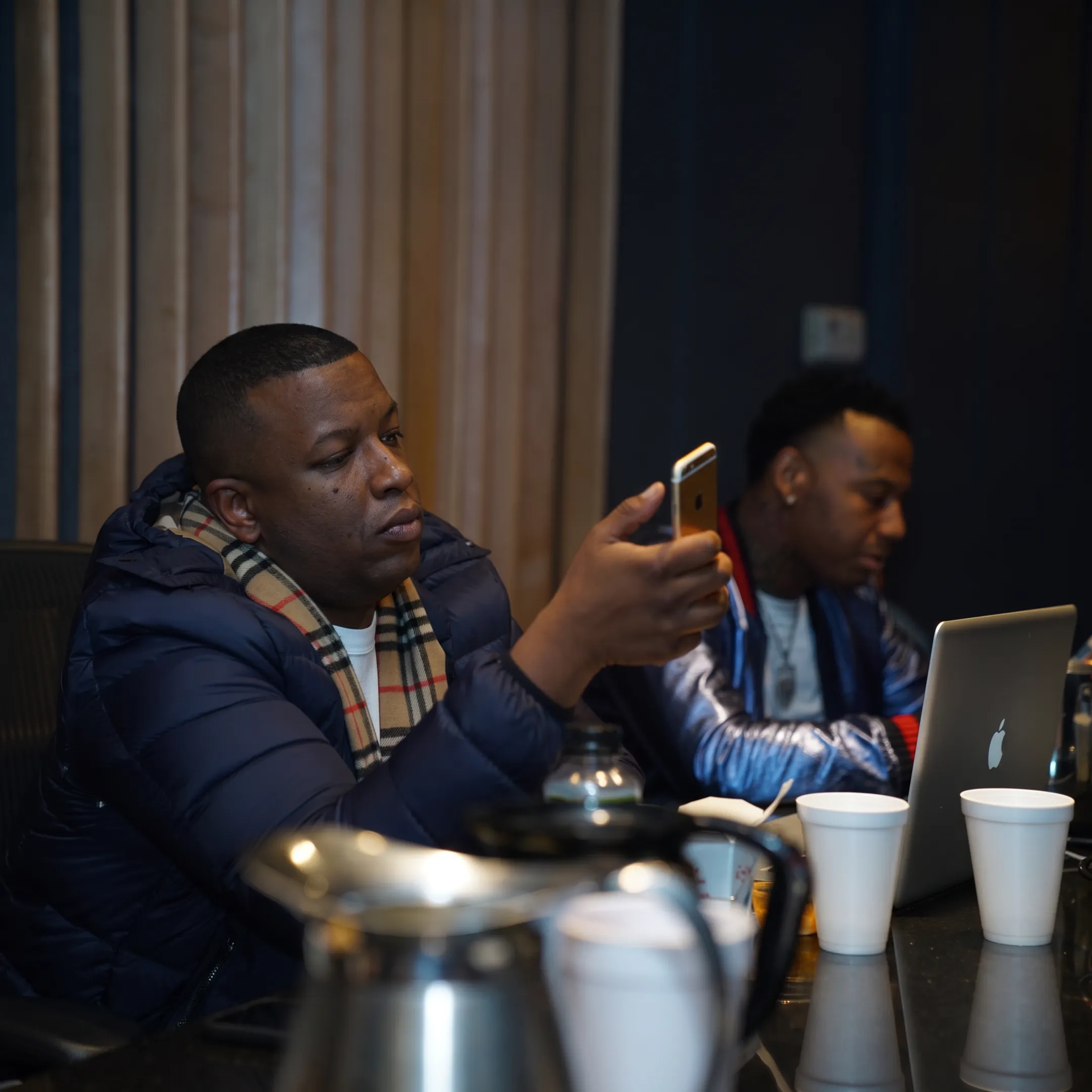 Artist manager meeting with musicians in a professional studio setting