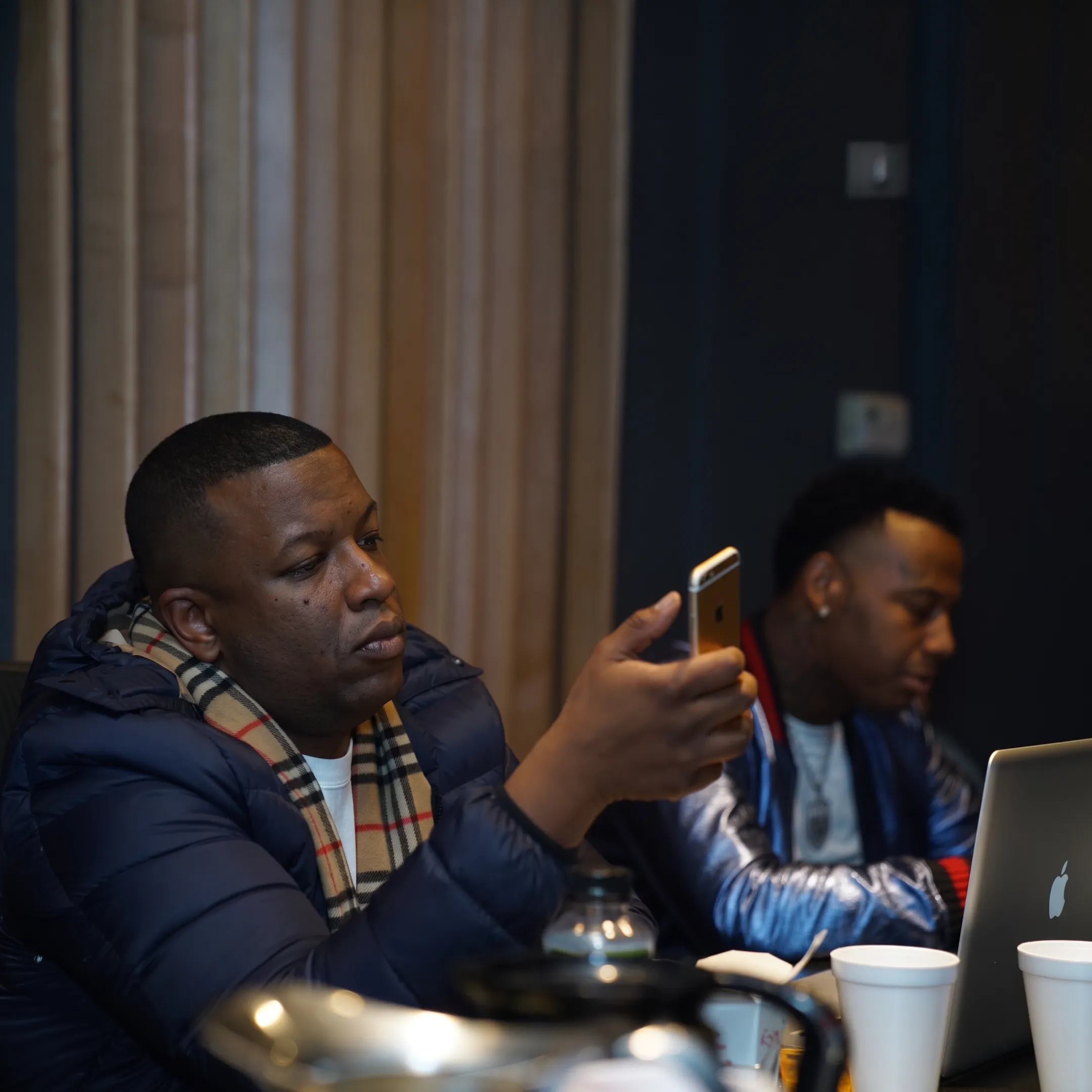 Music manager reviewing an artist strategy with performers in a Denver studio