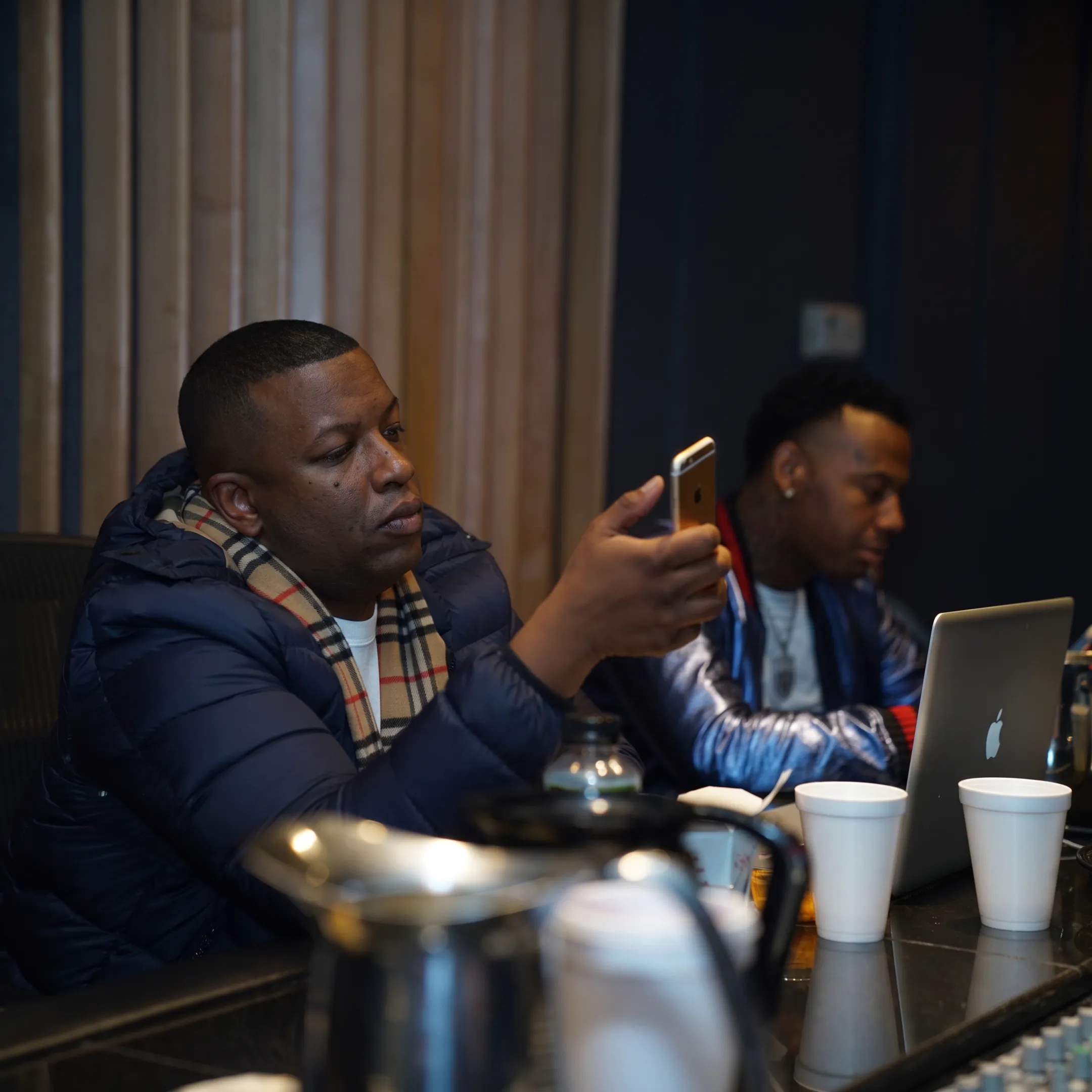 Music manager meeting with a singer to discuss career strategy in a recording studio