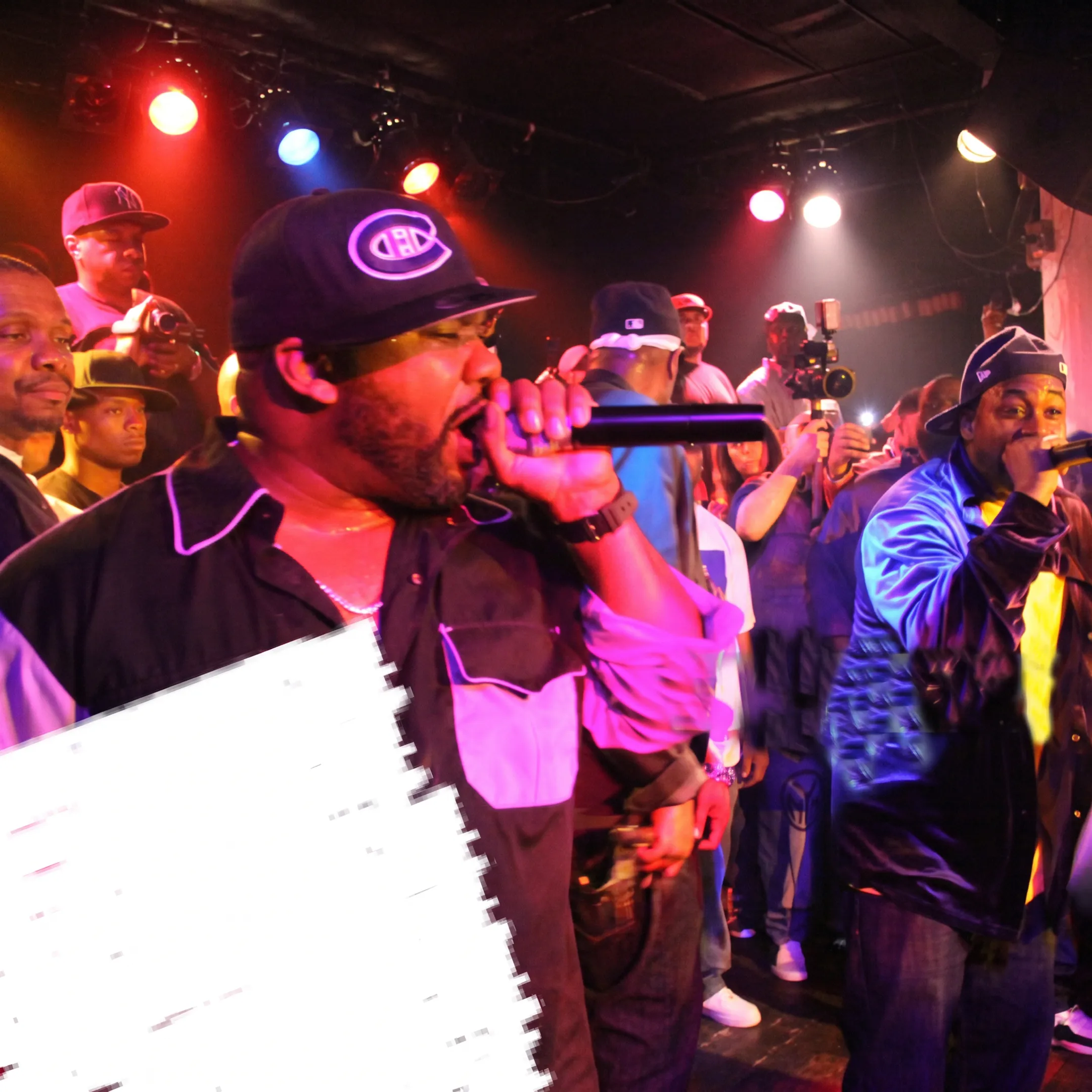 Event production team coordinating a live concert with performers, lighting, stage equipment, and an engaged audience
