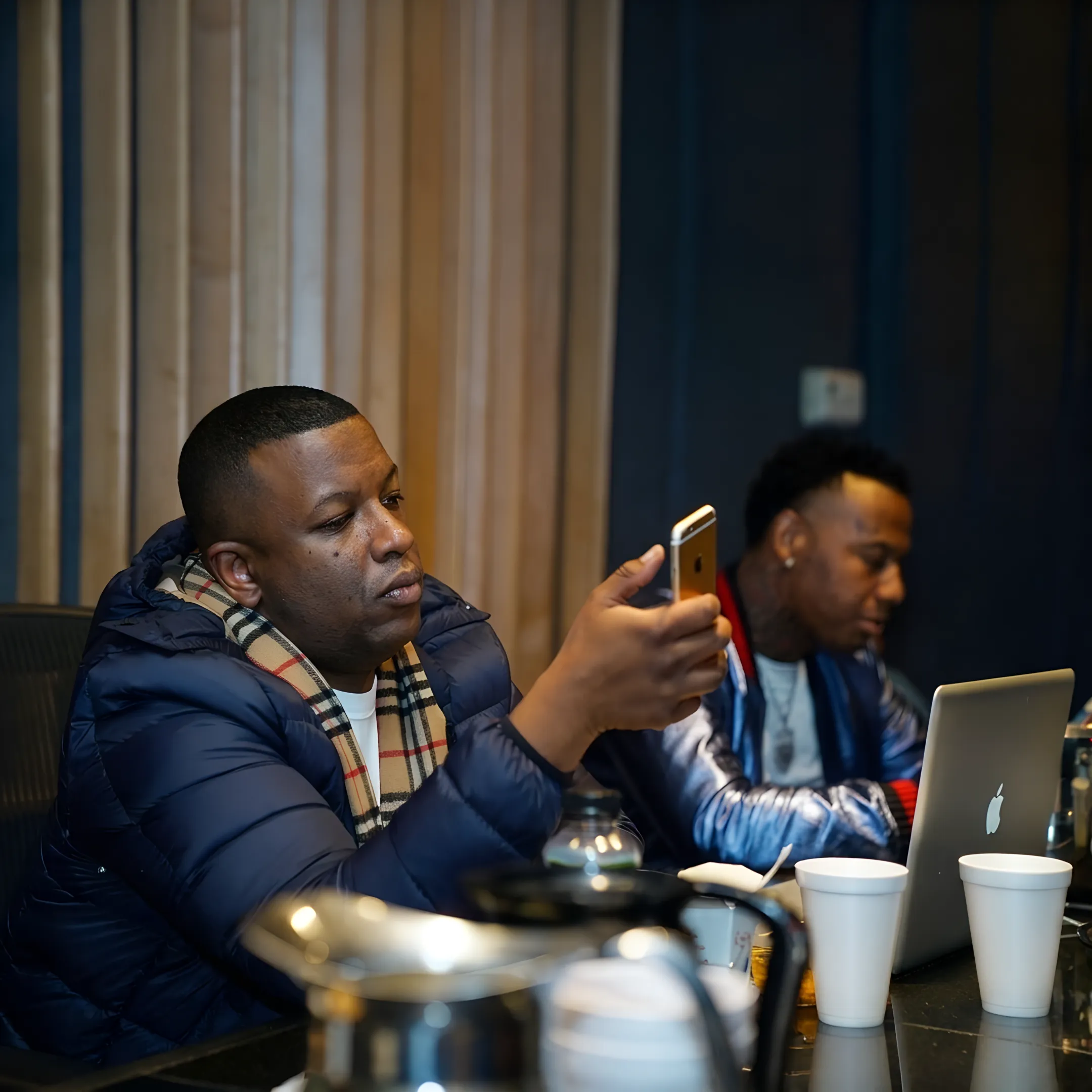 Artist and consultant discussing release strategy, brand identity, and career development at a studio table