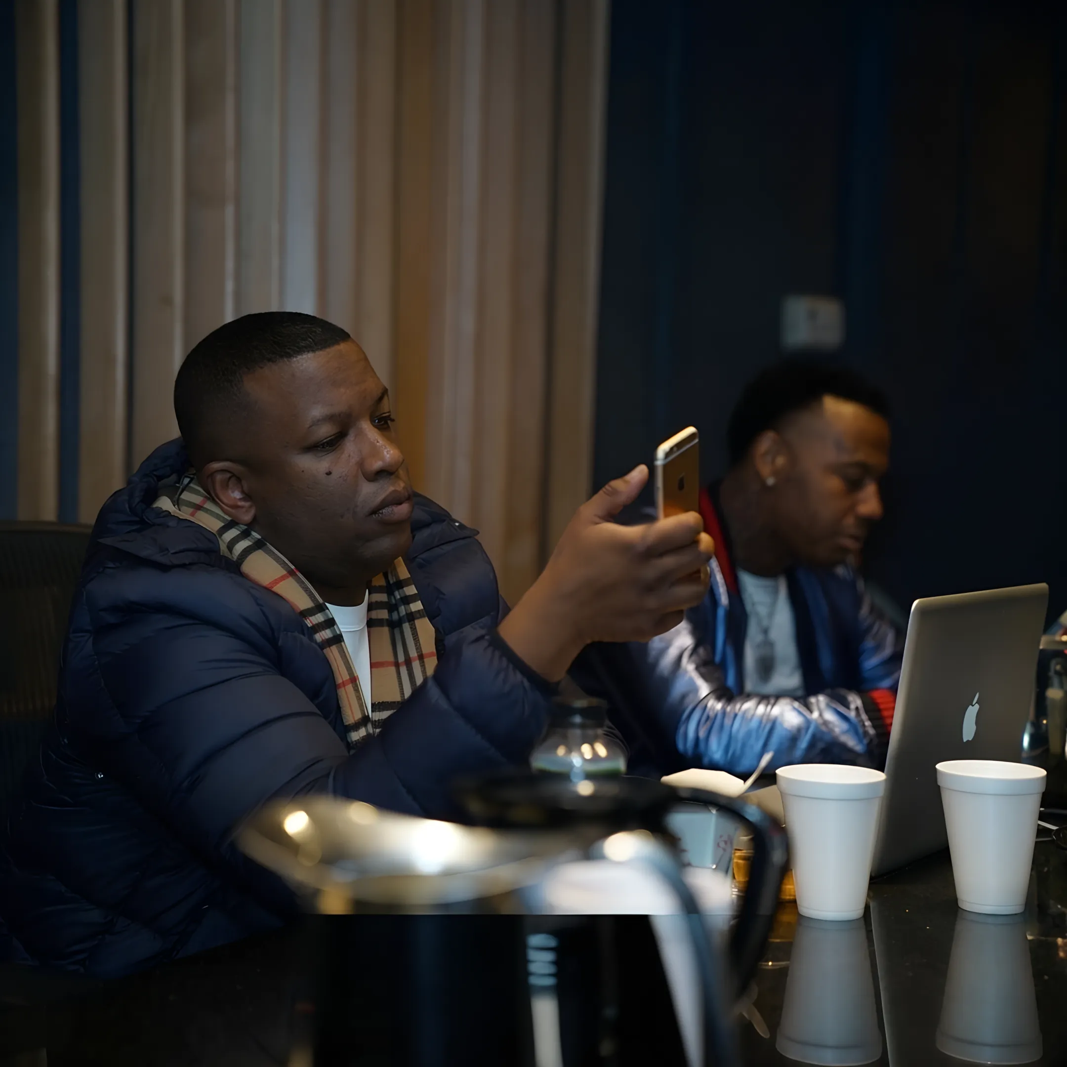 Artist development consultant reviewing music branding materials with an artist in a creative studio