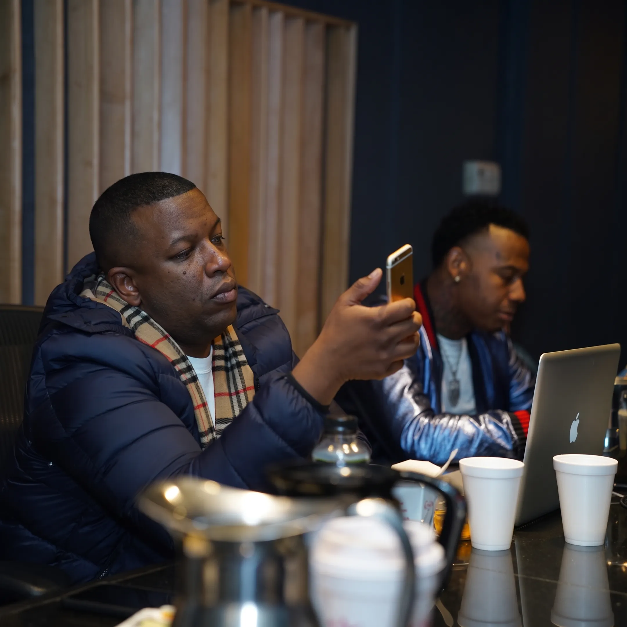 Artist and campaign strategist planning music video promotion materials at a creative meeting