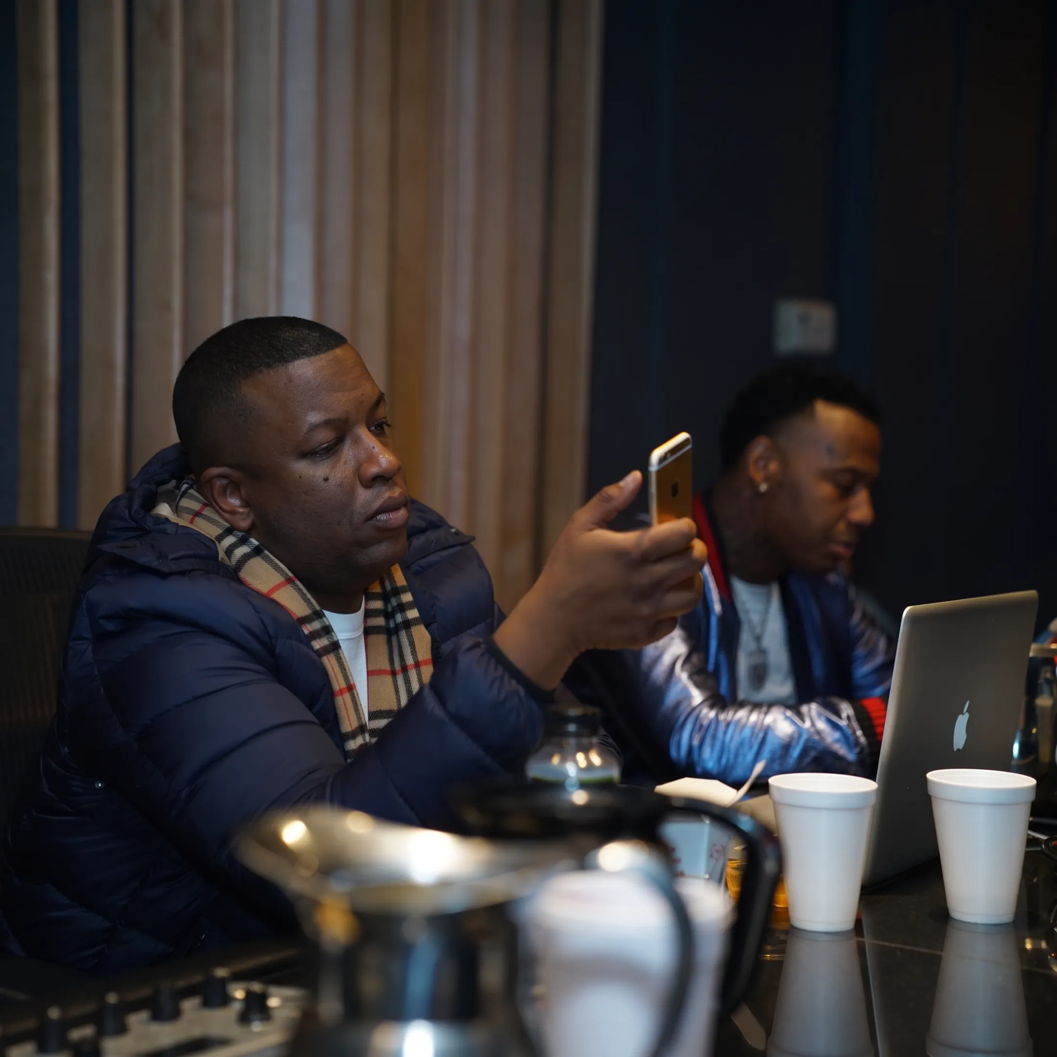 Music consultant discussing an independent artist’s release and booking strategy in a studio