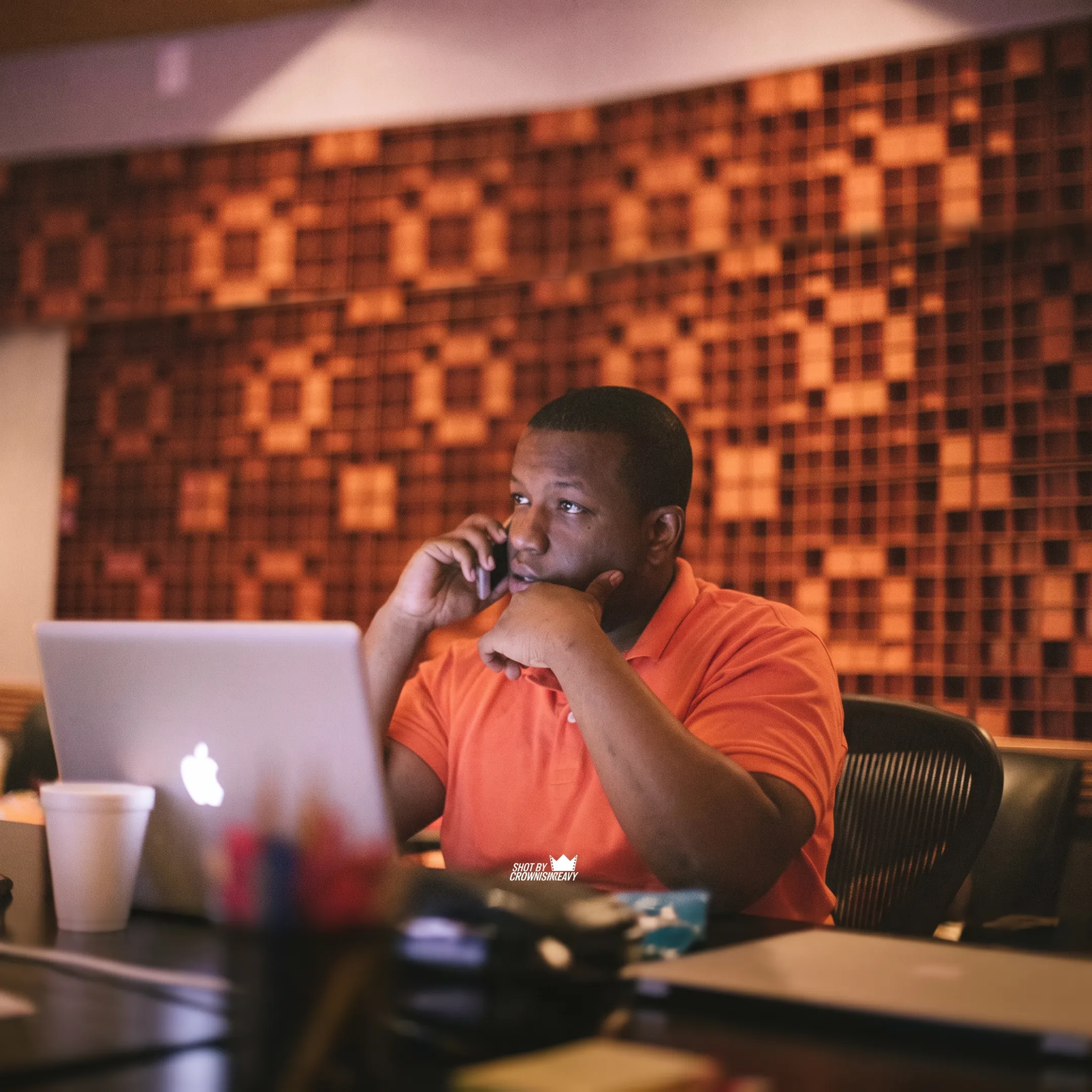 Independent artist recording music while reviewing a song promotion campaign with an entertainment consultant
