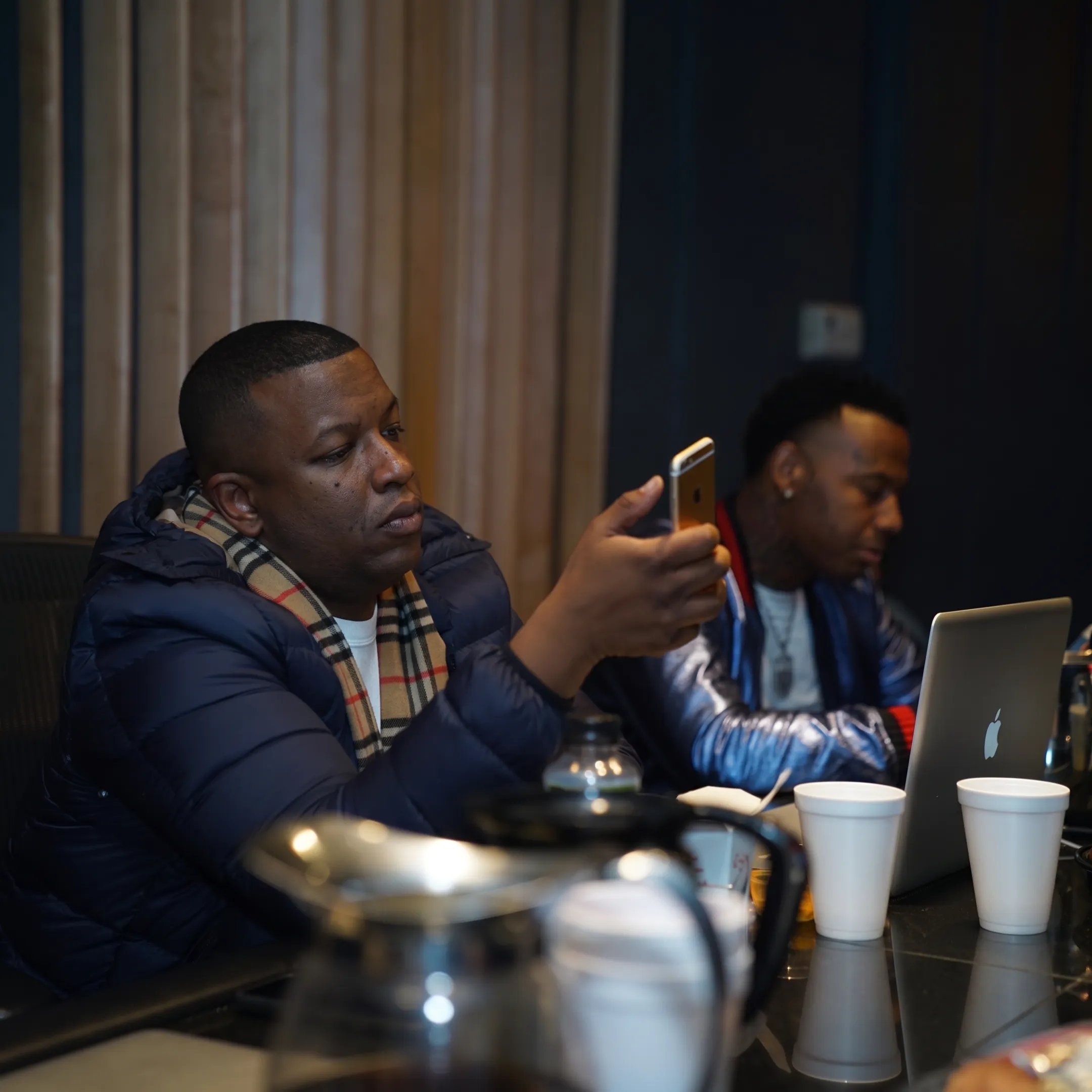 Music manager advising recording artist during a focused studio strategy meeting