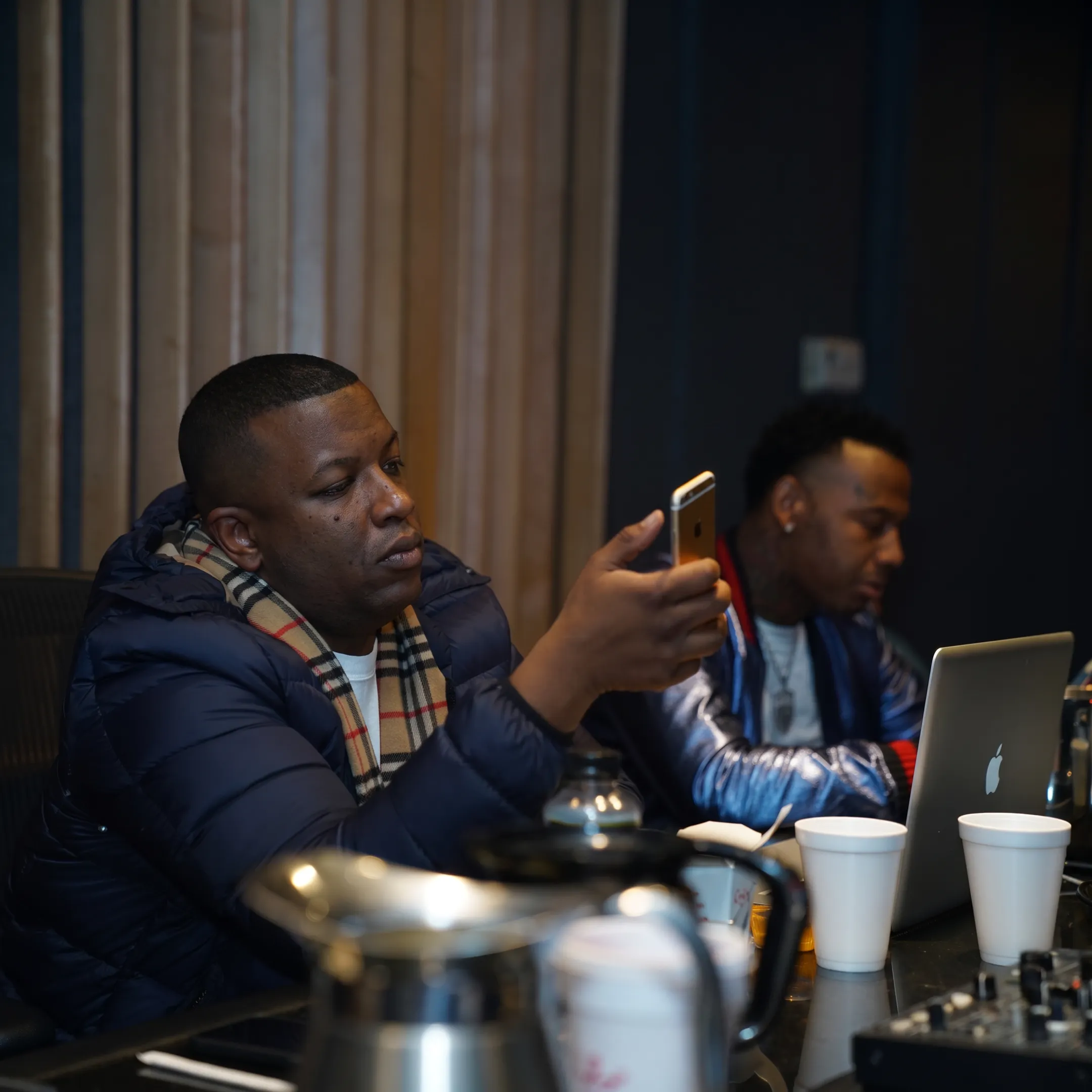 Hip-hop artist meeting with an experienced music manager in a creative studio