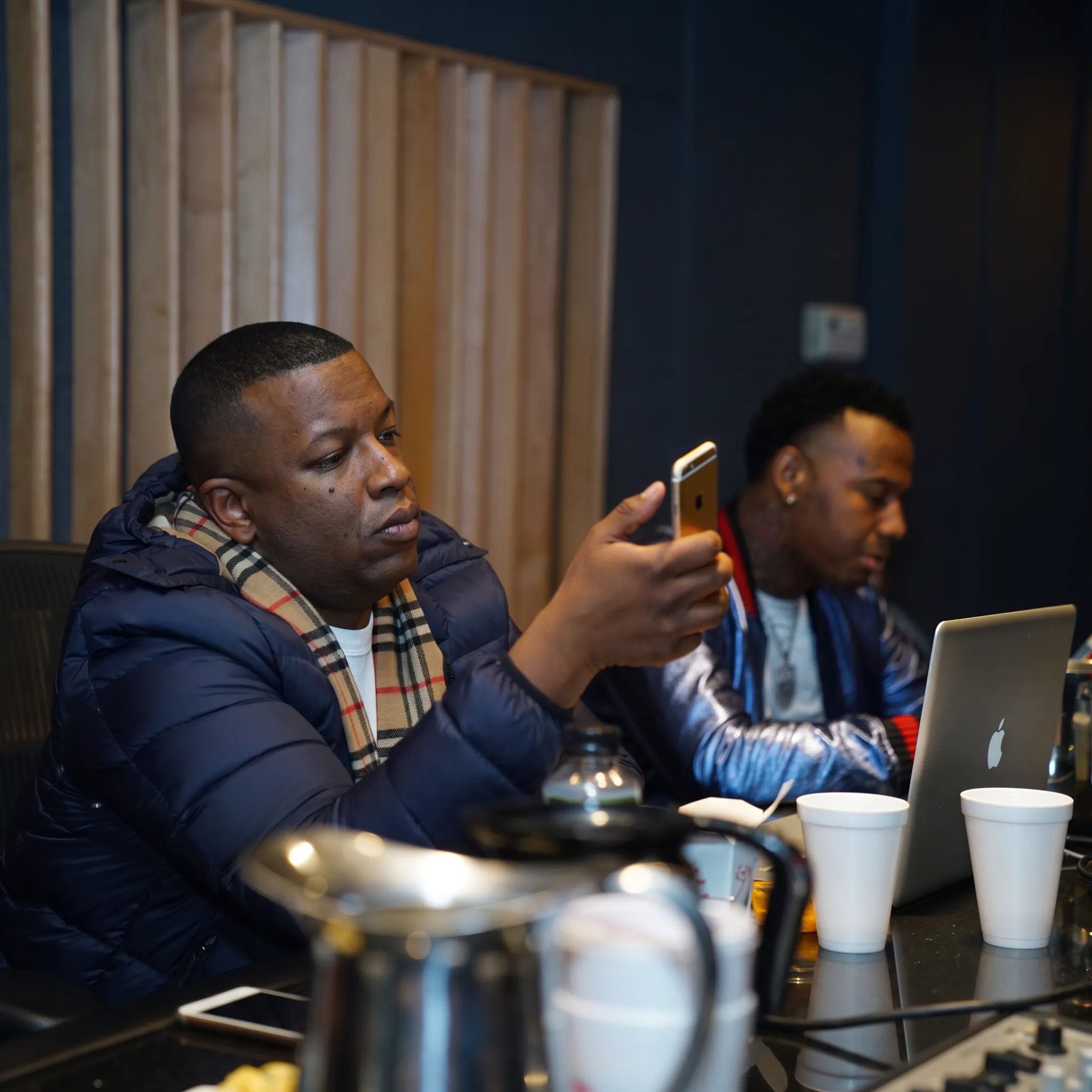Music manager advising recording artist during a focused studio strategy meeting