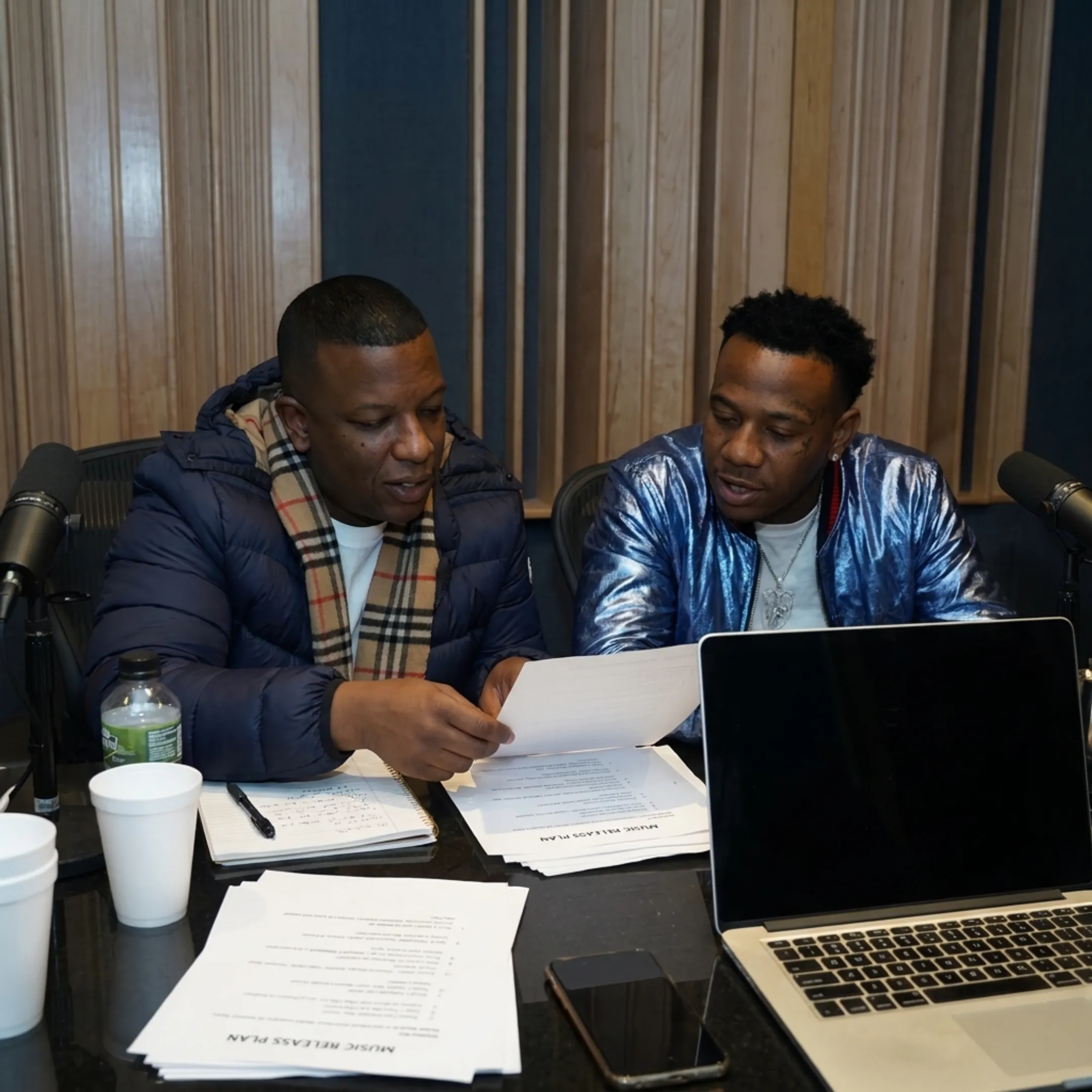 Entertainment manager consulting with an independent artist in a creative studio