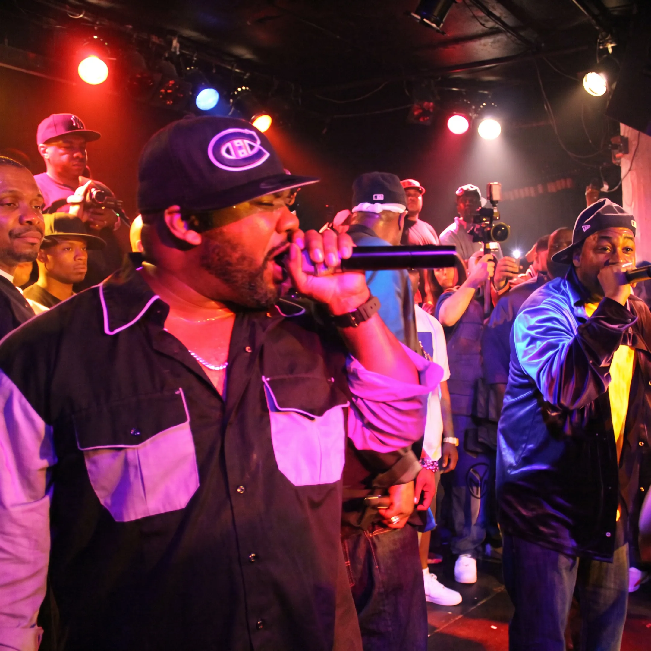 Independent artist performing at a packed club with promotional team nearby