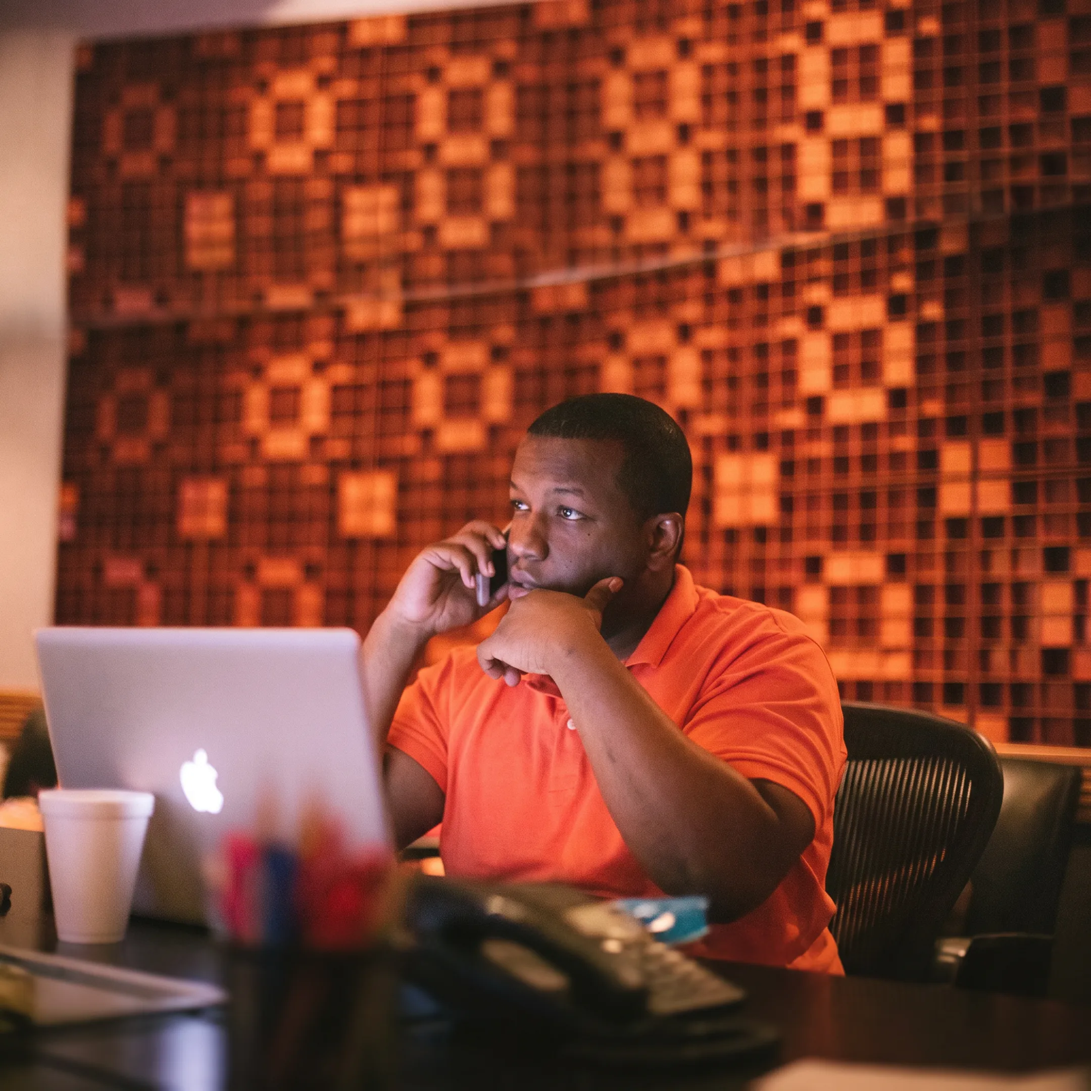 Music artist reviewing social media campaign content with a marketing consultant