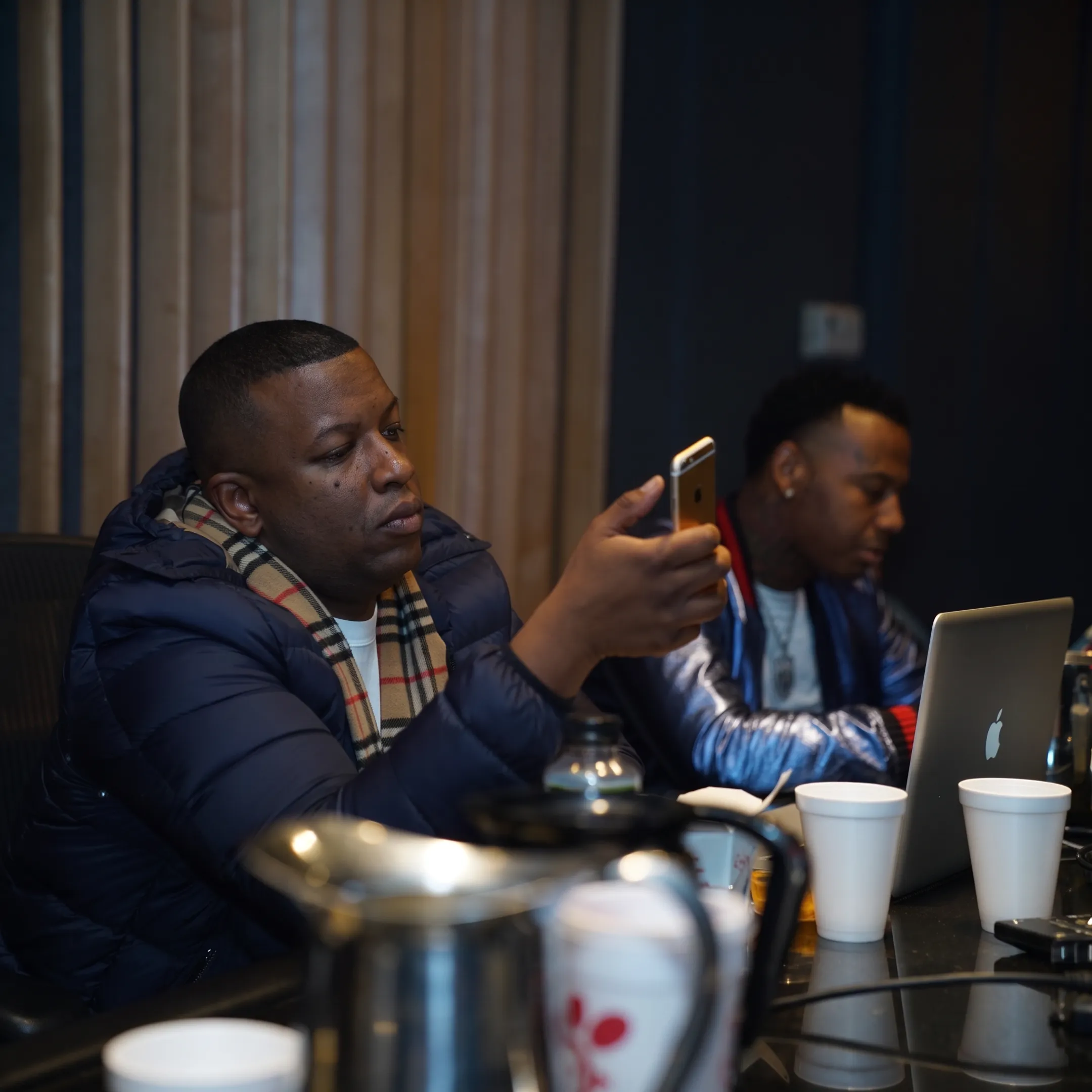 Music marketing team planning a release campaign with an artist in a creative studio