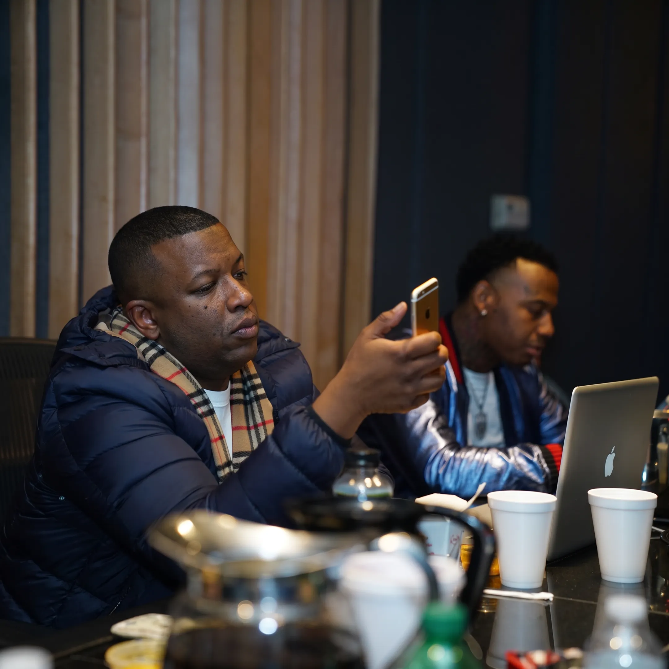 Music strategist reviewing an album rollout plan with an artist in a creative studio