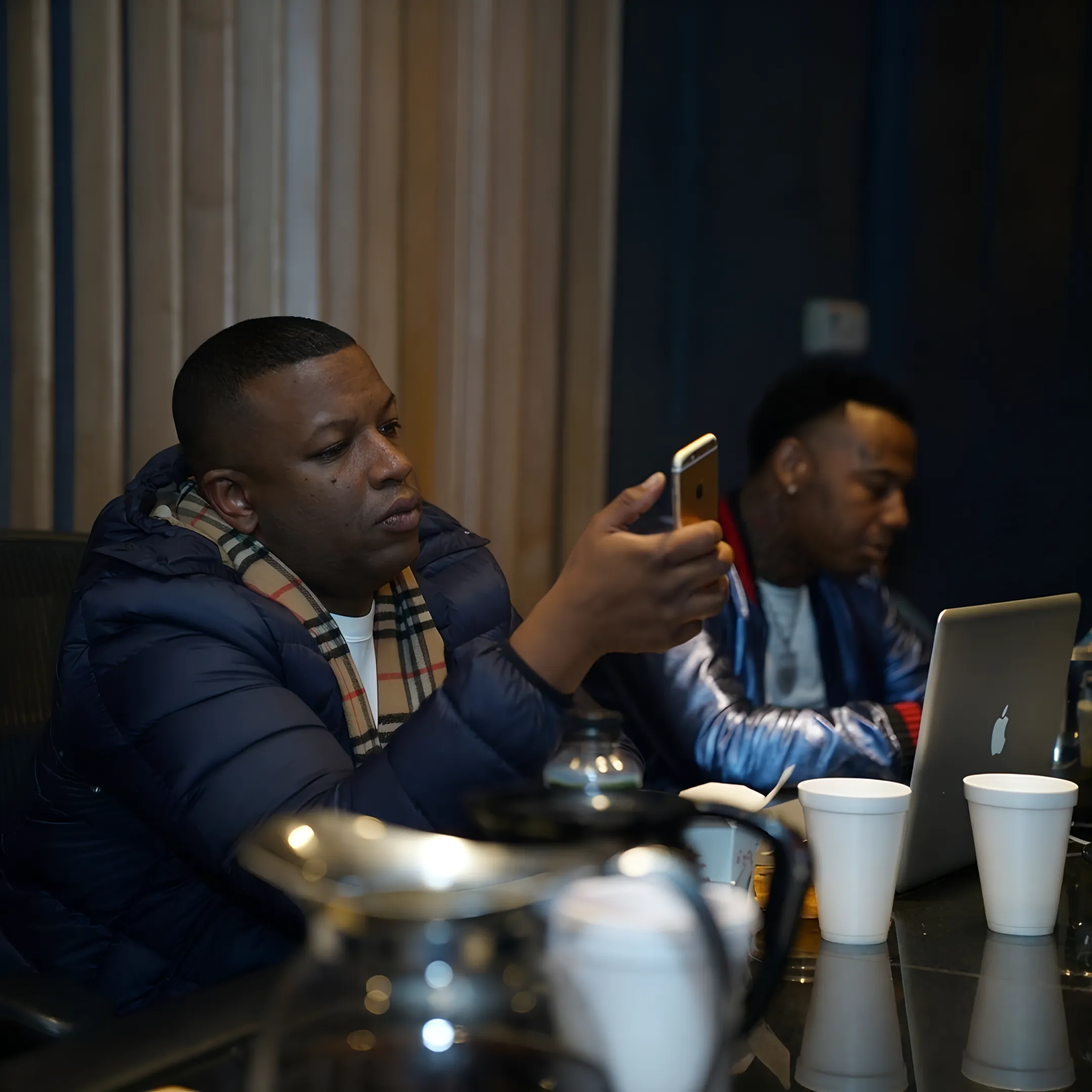 Music manager advising an independent artist during a focused studio consultation