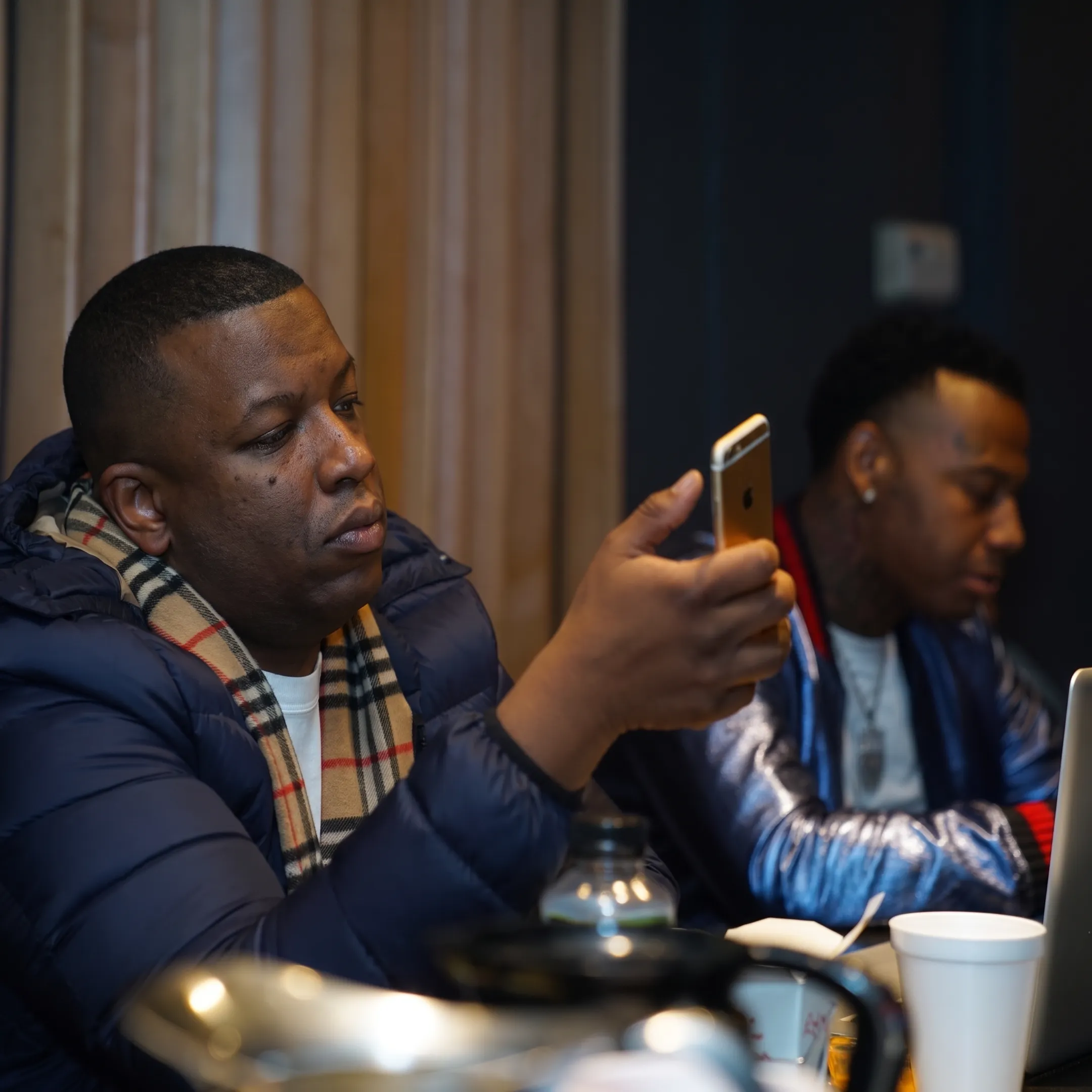 Independent hip-hop artist planning a publicity campaign with a strategic advisor