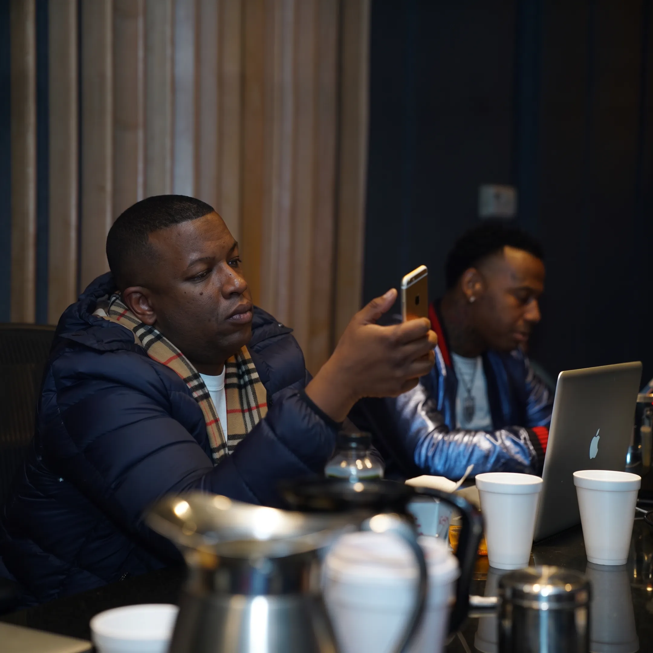 Hip-hop artist meeting with an experienced manager in a creative studio