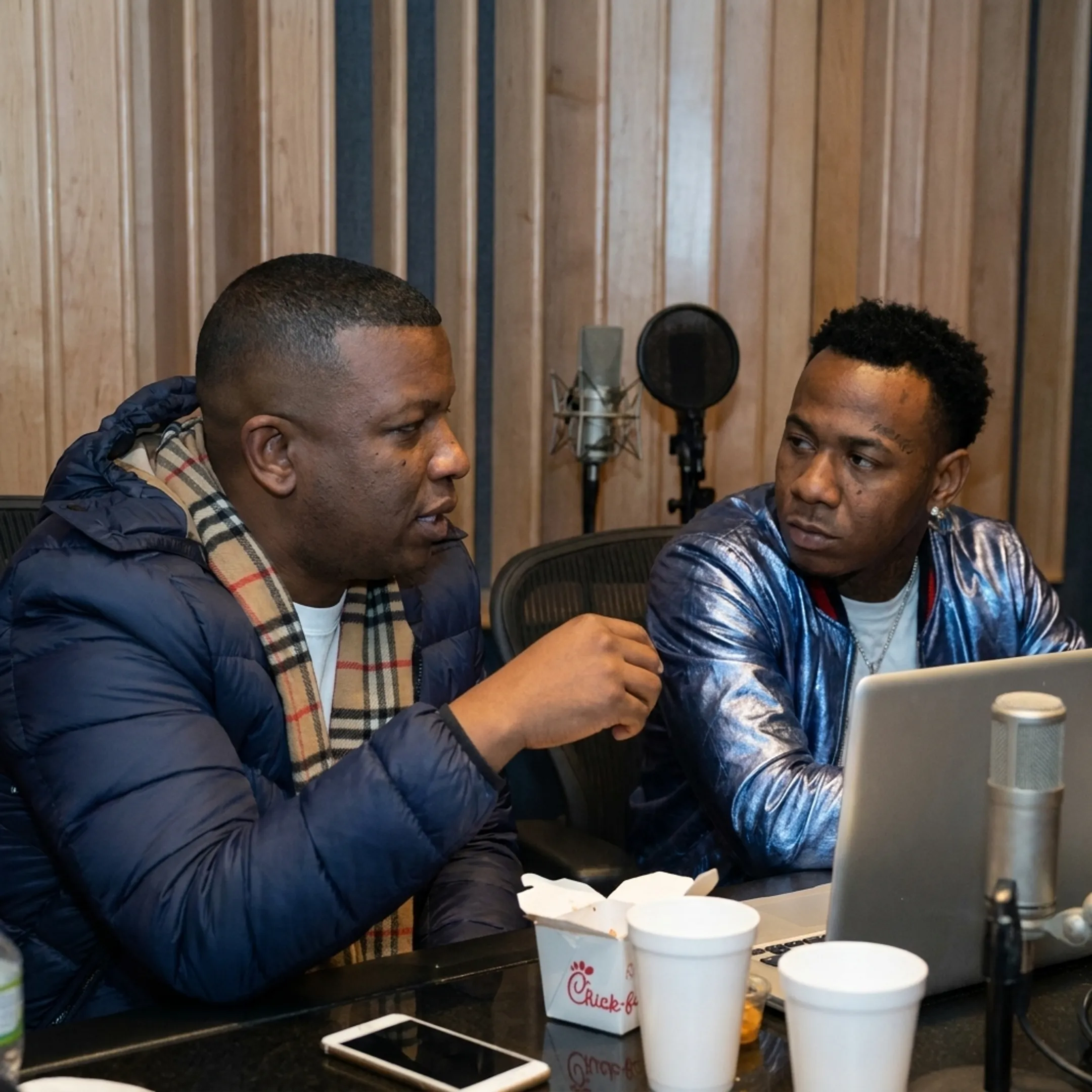 Entertainment manager advising an independent hip-hop artist during a strategy session